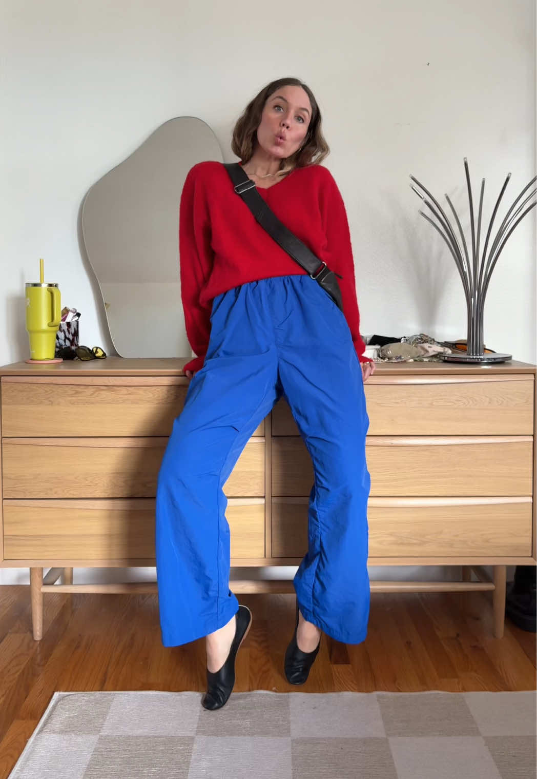 I usually reserve sporty pants for completely sporty looks that I wear around the house or while exercising (which means I’m not wearing them as much in outfit videos). But I had some time this weekend so I challenged myself to style them in not (only) sporty ways and these are the outfits I came up with! What I learned is that nylon pants are pretty easy to dress up (some of them literally read as dress pants to me - the shiny navy pair remind me so much of the winslow Tibi nylon trousers).  They’re also a great alternative to my more barrel-shape linen/cotton pants—these give a straighter silhouette as opposed to a more billowy one. They’re still just as comfortable, though (maybe even more comfortable). Some of them give a wide-leg shape, but I find that it’s a more relaxed look than, say, a wide-leg pair of jeans that can sometimes feel too rigid. Try just wearing whatever you would typically wear on top and then instead of your typical bottoms, throw on a sporty pair and see if it works. And as far as shoes, play around with sneakers for a more sporty look overall, a ballet flat or small heel to make the look skew feminine, or a loafer if you want masculine but not sporty. My favorite combinations are the ones where there’s a sweater on top. I think it’s because of the contrast in fabrics; wearing a similar-fabric top wouldn’t feel balanced to me, but the wool texture creates tension which makes an outfit interesting. What’s your favorite look?  #styleinspo #tomboylook #casualoutfitideas #outfitinspo 