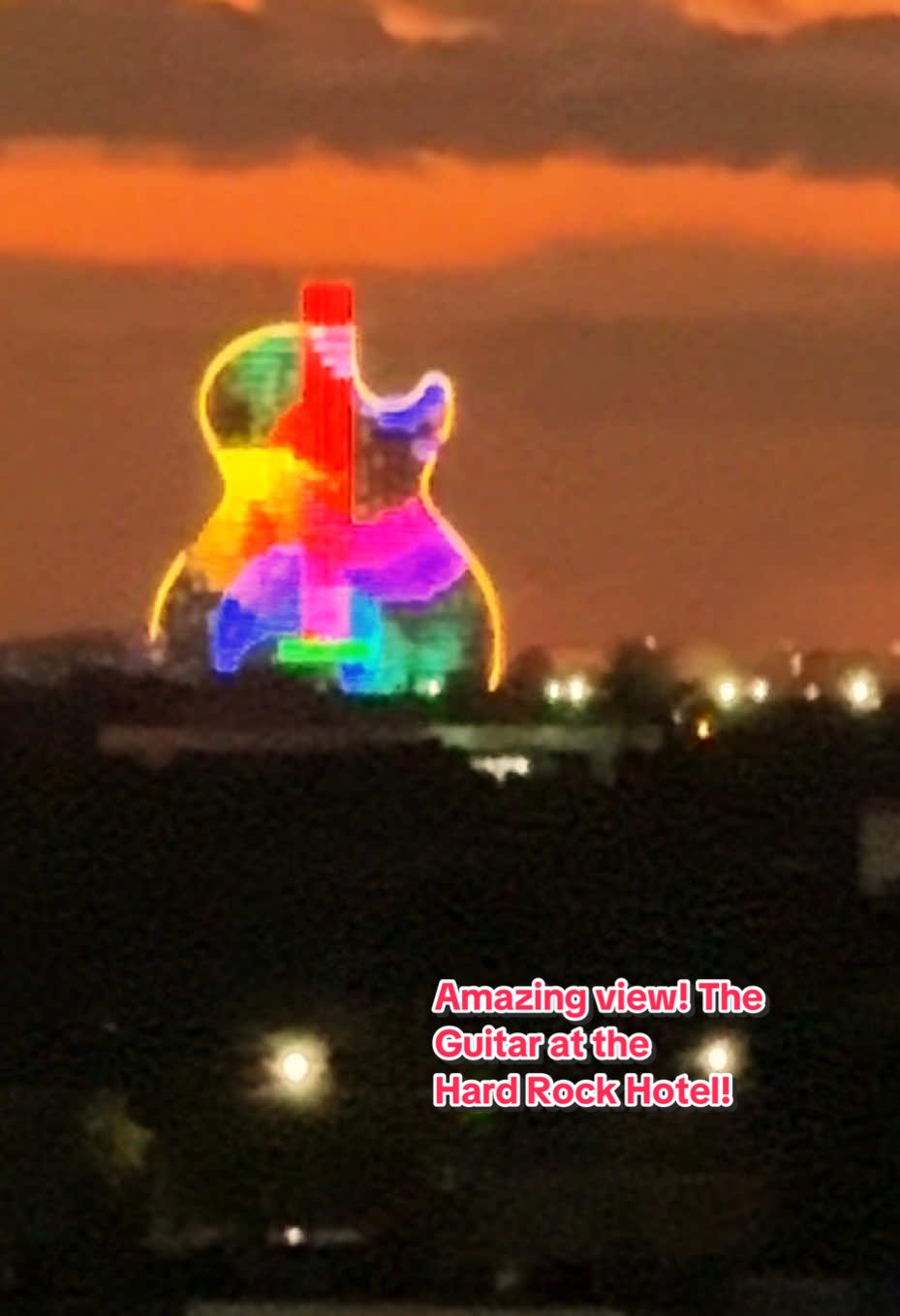 Amazing view! The  Guitar at the Hard Rock Hotel!  The Guitar Hotel brings 638 luxury guestrooms and suites to the resort. Designed to resemble back-to-back guitars, complete with guitar faces and brightly lit strings, this engineering masterpiece reaches 450 feet into the sky, outfitted with floor-to-ceiling glass panes. Boasting the sun-filled and sunset-laden South Florida skies, The Guitar Hotel is truly an architectural marvel that redefines the South Florida skyline. The Guitar Hotel Light Show The show is a daily spectacular featuring a series of orchestrated outdoor music and light shows showcasing the LED lights built into all sides of the brand new and immaculate The Guitar Hotel. The lights are programmed to change color and intensity and are choreographed to different songs. Six high-powered beams of light accentuate the production by projecting at least 20,000 feet into the sky. The six lights mimic the strings of an imaginary guitar neck. #amazing #views #guitar #hotel #travel  @perlacaribbean  @perlacaribbean  @perlacaribbean 