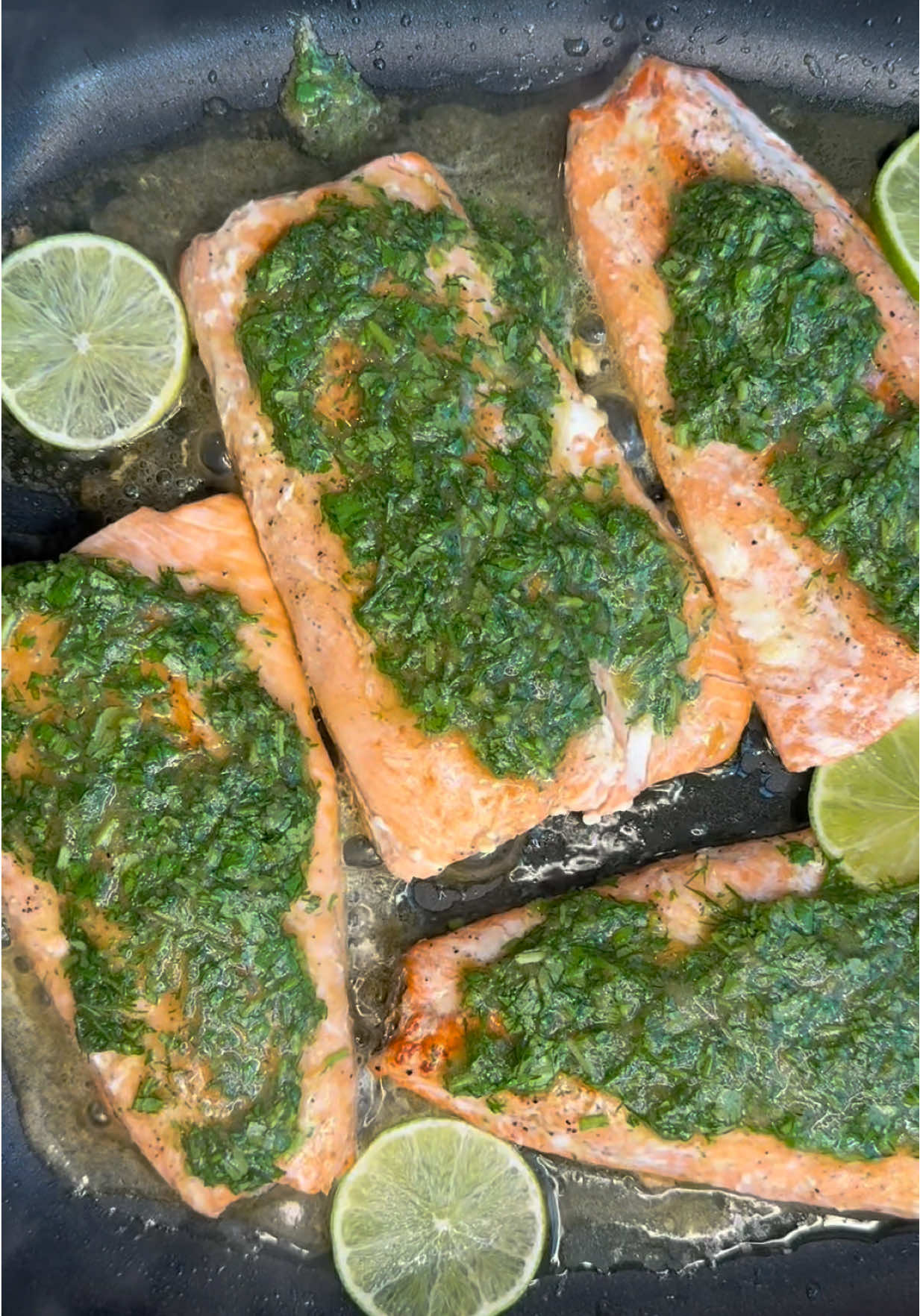 Lemony Herb Skillet Salmon!  Crispy on the outside, tender inside, juicy and  packed with fresh flavor!🍋 The green lemony sauce is everything!  Serve it with rice or potatoes, and drizzle that sauce on top (you will want extra)💚 Follow @ruhamasfood for more recipes! Check out my website: RuhamasFood.com RECIPE BELOW👇.                        Ingredients:  4-5 wild salmon fillets skin-on, seasoned with salt and pepper  2 tablespoons of extra virgin olive oil  1/2 teaspoon of flaky salt  4-5 slices of lime  Green lemony sauce:  Handful of fresh dill, chopped  Handful of fresh cilantro, chopped  1 clove of elephant garlic or 2 regular garlic cloves, minced  1 tablespoon of rice vinegar  2 tablespoons of coconut aminos 2 tablespoons of extra virgin olive oil  Juice from 1 lemon 1/2 teaspoon of flaky salt  1/2 teaspoon of ground black pepper  1 teaspoon of hot honey  -In a small bowl put all the ingredients and mix them well.  Method: 1. Heat a nonstick skillet over medium-high heat. Add olive oil and flaky salt. 2. When the oil is hot, place the salmon fillets skin-side down. Sear for 1–2 minutes. Don’t move them. 3. Flip the fillets and cook for another 1–2 minutes. 4. Add lime slices around the salmon fillets. 5. Spoon some of the green lemony sauce over each piece. 6. Serve warm over rice or potatoes. Enjoy! Ruhama 🤍#salmon #fishrecipe #fyp #juicy #ruhamasfood 
