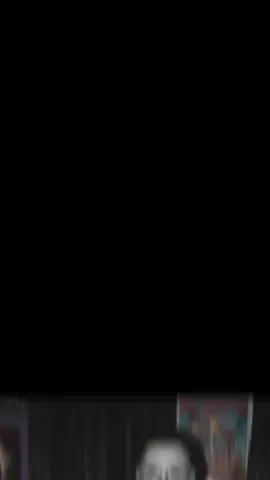 Create a photo of me in a dreamy y2k style portrait of me laying on a shiny pink satin bedding as i hold a large 90s style chorded phone and in a thoughtful daydreaming pose her long wavy hair gold butterfly clips on each side. she wears delicate jewelry including dainty gold necklaces and accessories and gold chunky rings. the room behind her is girly and daydreamy with 90s style posters. her makeup is simple yet glamorous with brown lipgloss and brown lip liner. the photo should have a grainy 90s style to it with a light source like a lamp in a dimly lit room at night. a bowl of popcorn rests beside her near some 90s style magazines. A guy with ghostface costume should be behind her staring at her, his body should be dimly lit, and he should be standing in the doorway of a dimly lit hallway. the background behind he should be slightly dark and ominous #ghostfacecosplay #gemini #geminiai #ghostface #michaelmyers 