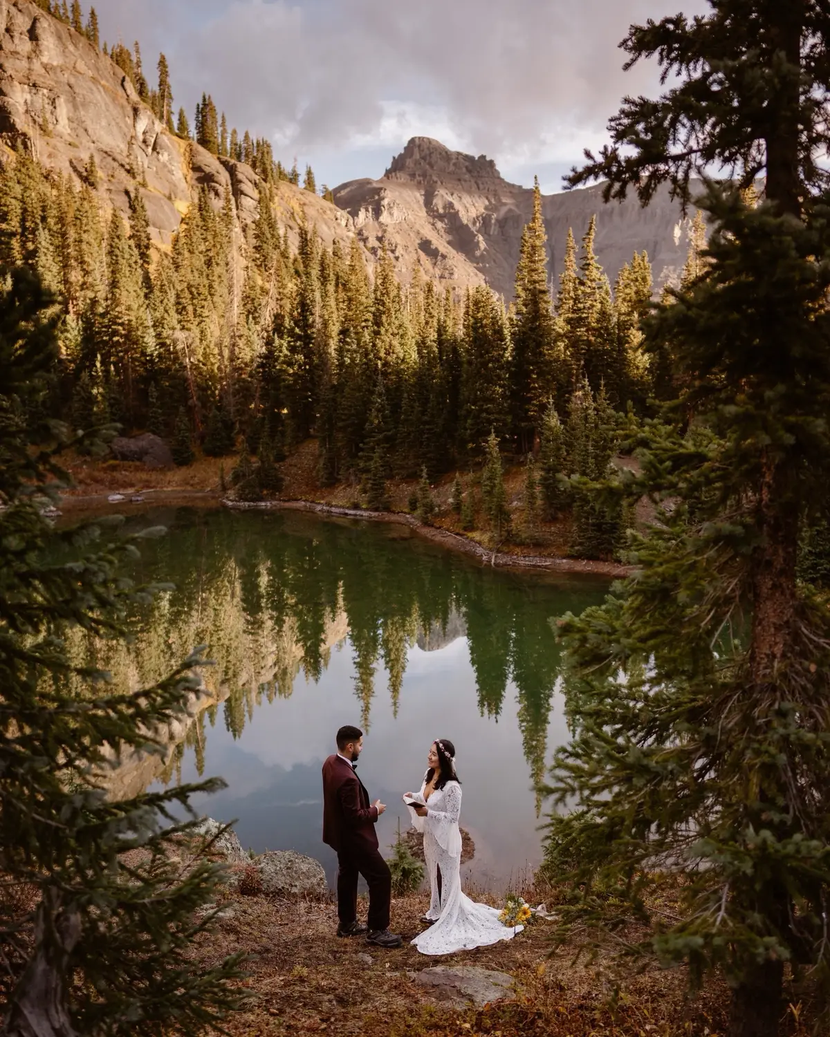 Every time I hear that folks want to include their pup in their wedding day (which I am ALL FOR by the way), I point them to Melissa & Jonathan’s Colorado elopement day.  While they initially made the choice to elope because they had been to big weddings in the past that the couples hosting hadn’t loved, they realized that they also had a huge perk… their beloved pup, Yoshi, could come with for the whole day!  They had a lakeside ceremony, playing rock paper scissors to see who would get to read their vows first. Their vow reading was super emotional, and I don’t think any of us made it out without getting teary.  Yoshi stood by in a tuxedo, looking his best, playing the important role as Best Man for the wedding. He would also later sign their marriage license with his paw print as their officiant, which you can do in Colorado!  After the ceremony, Yoshi had a snack of kibble while Melissa & Jonathan popped champagne and toasted to being just married 🥂 They settled in for a picnic in the same spot they got married in, spreading out a beautiful breakfast full of berries and charcuterie goods. Before they headed back to the car, Yoshi donned a new bandana proclaiming that his humans got married.  Melissa & Jonathan had rented a 4X4 for the day, so they drove their Jeep through mountain passes to see waterfalls, other alpine lakes, and aspen groves.  At some point it started to sprinkle, and Yoshi got an express air lift over muddy patches of the trail! But for the most part he hiked steadily right behind them, just happy to be included.  He even sat by for emotional support while Melissa & Jonathan read letters from their loved ones, stretched out on the blanket right beside them.  I wrote a blog post all about this beautiful day, which you can read! Just comment MELJON and I’ll send you the link!  We just passed these two’s 3rd wedding anniversary, so everyone wish them a happy anniversary in the comments!  Melissa & Jonathan, thank you so much for letting me document your day. I still think back on this one super fondly.  xx Maddie Mae . . . #dogsatwedding #intimatewedding #momentsovermountains #elopementideas #adventurebride