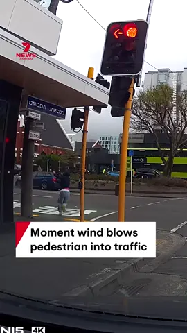 Dashcam footage has captured the moment a strong gust of wind appears to blow over a pedestrian and send them stumbling and tumbling onto the road and into traffic in Wellington. Intense winds have battered parts of New Zealand. #wind #wildweather #dashcam #Wellington #NewZealand