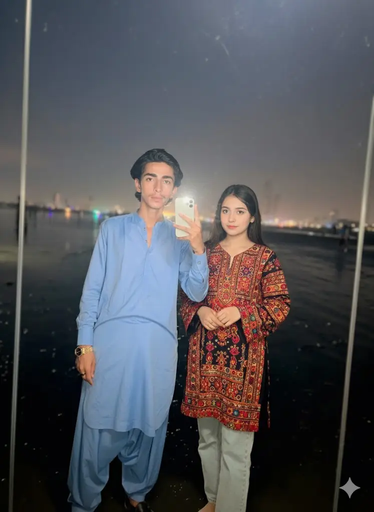Add a young woman standing next to me natural pose casual outfit (denim, Balochi dress shirt) realistic lighting matching the mirror selfie.her style should be blend naturally with my appearance. make it look like a real candid mirror photo with both of us together.