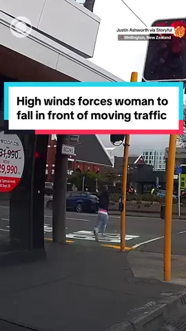 High winds pushed a woman so hard that she fell in front of moving traffic in Wellington, New Zealand. Video showed the pedestrian losing footing while trying to cross a street. Authorities said the powerful winds killed a man on Oct. 21 after he was hit by a falling branch in Wellington. #wellington #newzealand #winds 