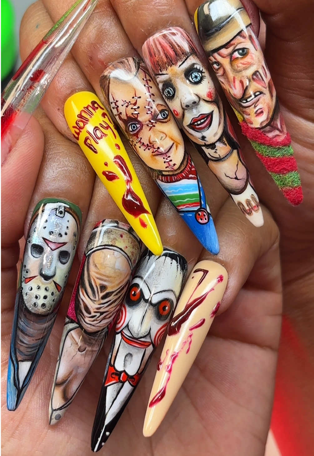 I turned my nails into a horror movie marathon😭 Every horror icon… handpainted. Which one’s your favorite victim? Comment below! 🔪 It was a blast painting these with you all on live :) what a pleasure it was! 🖤 Products from @LizRenayShop  Showing off Renays gloss top coat & Paint monster in the vid!  Use code “slime” to save 🧪 • • #halloweennails #nailart #spookynails #halloweennailart #portraitnails 