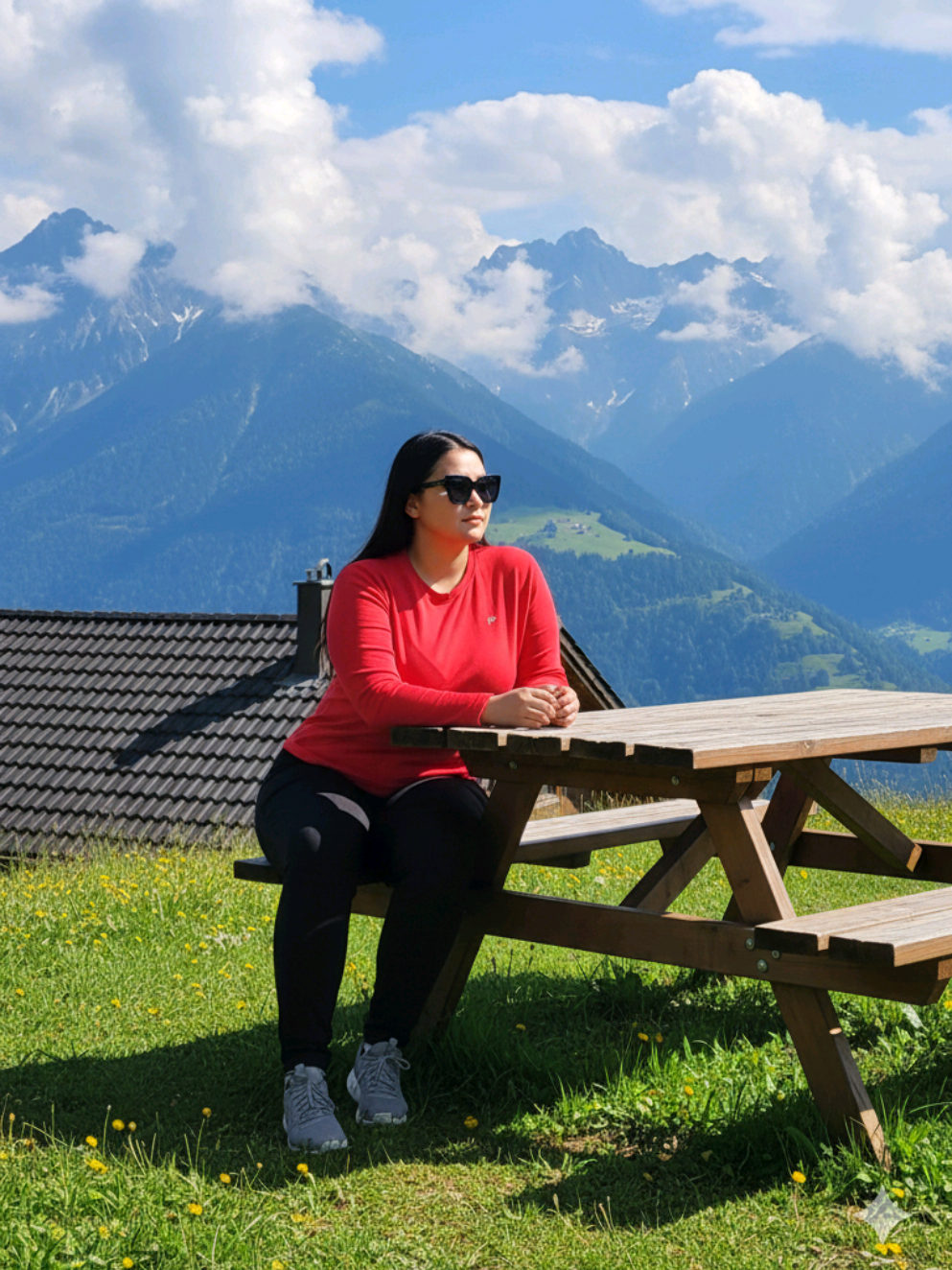 Prompt Gemini Ai wanita duduk dengan pemandangan gunung Buatkan gambar hyper-realistic, wajahnya sama persis dengan foto referensi (100% tanpa perubahan pada wajah, mata, struktur wajah, alis, hidung, bibir dan juga jangan merubah bentuk badan) Seorang wanita duduk dengan tenang di meja piknik kayu di luar ruangan dengan pemandangan pegunungan yang menakjubkan di latar belakang. Ia mengenakan atasan lengan panjang merah, celana hitam, dan sepatu kets abu-abu, serta kacamata hitam. Pemandangannya cerah dan jernih dengan langit biru, awan putih yang berarak di sekitar pegunungan, dan rerumputan hijau dengan bunga-bunga kuning yang bertebaran. Atap kabin kecil dengan genteng gelap terlihat di belakangnya. Ia memandang ke samping menikmati sinar matahari, menciptakan suasana perjalanan yang damai dan alami. Pencahayaan beresolusi tinggi dan realistis, fotografi siang hari di luar ruangan, pose alami, dan komposisi yang seimbang, beresolusi sangat tinggi, 8K, fokus tajam, detail tajam. #fyp #fyppppppppppppppppppppppp #fypシ゚ #fypage #liburan 