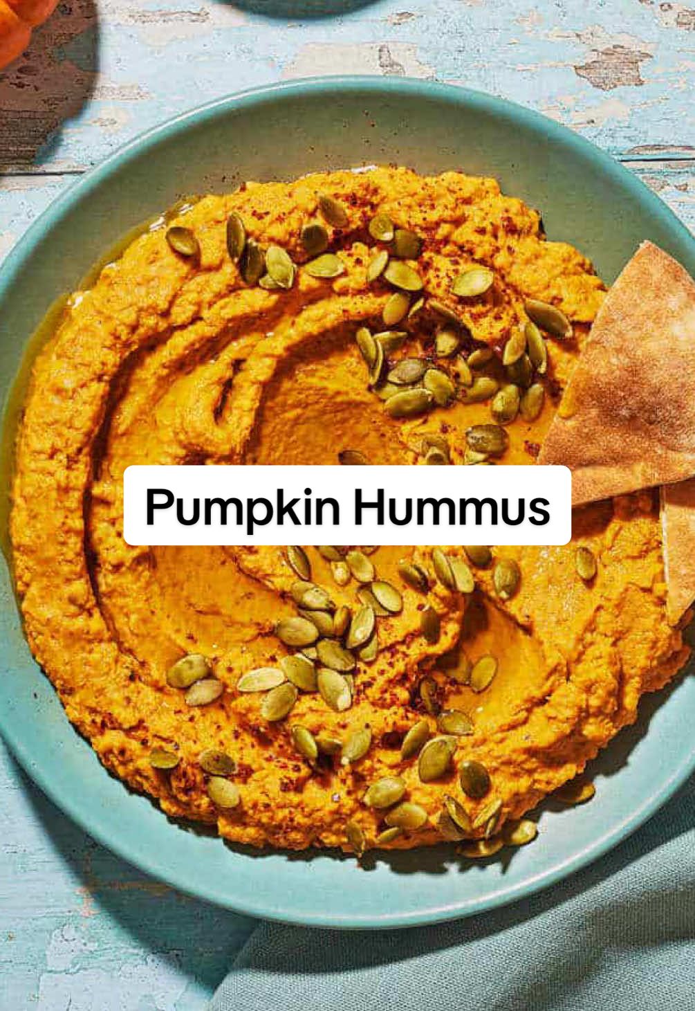 Pumpkin Hummus (Hummus Recipe!)  This savory pumpkin hummus is layered with subtly smoky flavor and warming Mediterranean spices. Serve with pita chips for an easy appetizer that takes 10 minutes or less. Perfect for fall spreads and Halloween parties. #hummus #pumpkin #pumpkinrecipes #pumpkinrecipe #hummusrecipe  You don’t need to do much heavy lifting for this pumpkin hummus recipe. Simply stock up on some cans and basic pantry essentials and blend. Here’s what you need: ▢1 (15-ounce) can chickpeas and their liquid (undrained) ▢1 (15-ounce) can pure pumpkin puree ▢2 medium garlic cloves, minced ▢1/2 teaspoon cumin ▢1/2 teaspoon smoked paprika ▢1/2 teaspoon red pepper flakes or Aleppo pepper, plus more for garnish ▢Kosher salt ▢Black pepper ▢3 tablespoons tahini ▢Juice of 1 lemon ▢Extra virgin olive oil ▢Roasted pumpkin seeds or toasted pepitas, for garnish (optional) ▢Pita chips, crackers, or crudité, for serving 1. Separate the chickpeas and their liquid. Set a strainer over a bowl and pour the canned chickpeas through the strainer, reserving both the liquid and chickpeas. 2. Get ready to blend. To the bowl of a food processor fitted with a blade, add the chickpeas, pumpkin puree, garlic, tahini, and lemon juice. Season with the cumin, smoked paprika, red pepper flakes or Aleppo pepper and a big pinch of kosher salt and black pepper (about 1/2 teaspoon each). 3. Blend and thin. Close the lid and run the food processor to blend. The mixture will be thick at first. While the food processor is running, add in splash of the reserved chickpea liquid. Continue to blend, adding a little bit more of the liquid as needed until the mixture is smooth and creamy. 4. Season to taste. Taste and adjust the seasoning to your linking. If you end up adding any more seasoning, you can pulse a few times to make sure the mixture is well blended. 5. Assemble and serve. Transfer the pumpkin hummus to a bowl and spread with the back of a spoon. Drizzle a bit of olive oil and finish with pepitas or roasted pumpkin seeds and a sprinkle of red pepper flakes or Aleppo pepper (if using). Serve with pita chips or crackers of your choice.