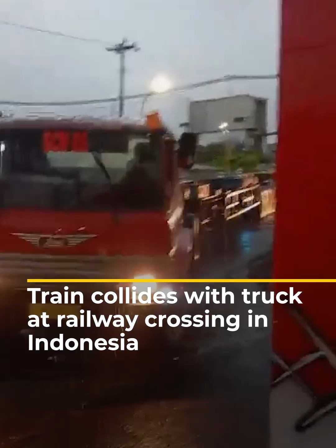 Dramatic footage shows a train colliding into a semi-truck that was stuck on a level crossing in Indonesia's Semarang City.  . No injuries were reported. #news