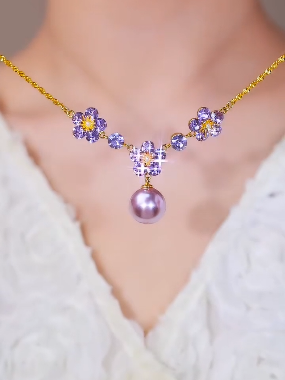 ✨ قلادة اللؤلؤة البنفسجية ✨ تألّقي بإطلالة راقية تجمع بين الأنوثة والفخامة 💜 تصميم فريد من زهور كريستالية بنفسجية تتوسّطها لمسة ذهبية أنيقة، تتدلّى منها لؤلؤة بنفسجية لامعة تضيف لمسة من السحر لكل مناسبة 💫 مثالية للهدايا والمناسبات الخاصة #هدايا_نسائيه #قلادة #اللؤلؤة_البنفسجيه #اناقة #اكسسوارات_نسائية 