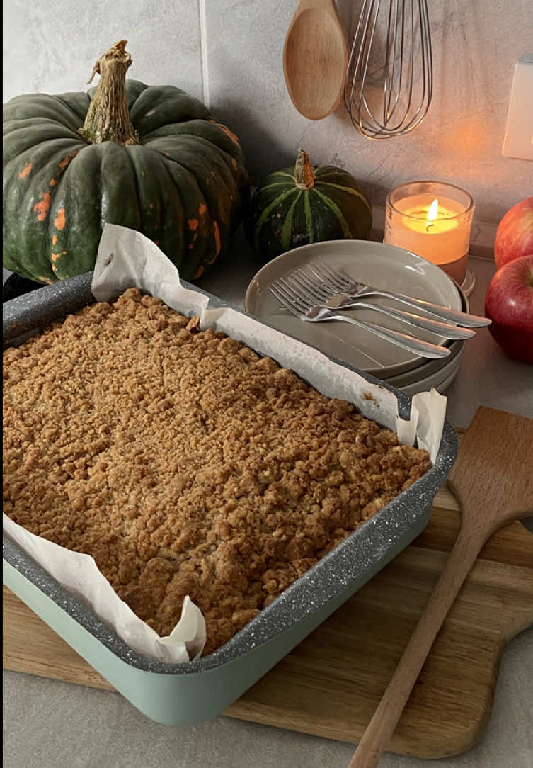 Nothing says fall quite like an Apple Crumb Cake with a touch of cinnamon spice. 🍎 - INGREDIENTS: Crumb Topping: 200 g Brown sugar 100 g Granulated sugar 1 tbsp Cinnamon 1/2 tsp Salt 226 g Melted butter 313 g Flour - Cake: 313 g Flour 1 tsp Baking soda 1/2 tsp Baking powder 1/2 tsp Salt 170 g Butter (room temperature) 250 g Granulated sugar 3 Large eggs (room temperature) 240 g Sour cream (room temperature) 2 tsp Vanilla extract 375 g Apples (2 or 3 apples) 1/4 tsp Cinnamon - INSTRUCTIONS: Start by making the crumb topping: mix the brown sugar, granulated sugar, cinnamon, & salt. Add the melted butter & mix. Then add the flour & mix with a fork until crumbles form. Let it rest in the fridge while making the cake. Make the cake: in a bowl, mix all the dry ingredients & set it aside. Using a hand or stand mixer, beat the butter & sugar on high speed for about 3 minutes. Add the eggs, sour cream, & vanilla extract & combine on medium-high speed. Mix in the dry ingredients on low speed until smooth. Do not overmix. Peel & cut the apples, put them in a bowl & sprinkle them with cinnamon. Get a 23 x 33 cm (more or less) baking tray covered with parchment paper, & pour the cake batter. Add the apples on top & finally the crumb topping. Flatten everything with a spatula. Bake at 177°C for about 50 minutes or until an inserted toothpick comes out clean. #applecrumbcake #crumbcake #fallbaking #applecake #applecrumble 