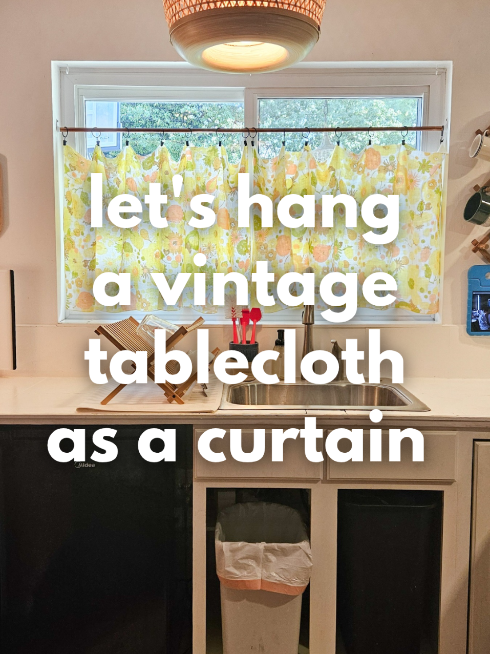 The 1970's vintage tablecloth is transformed into a cafe style curtain for the kitchen & the pile of things to hang on the walls is shrinking! It always feels great to put the items we own & love to good use instead of the items living in a pile of unfinished projects. 🩷🏵🍓🪟 #VintageKitchen #1970s #Curtains #UnfinishedProjects #KitchenCurtains 