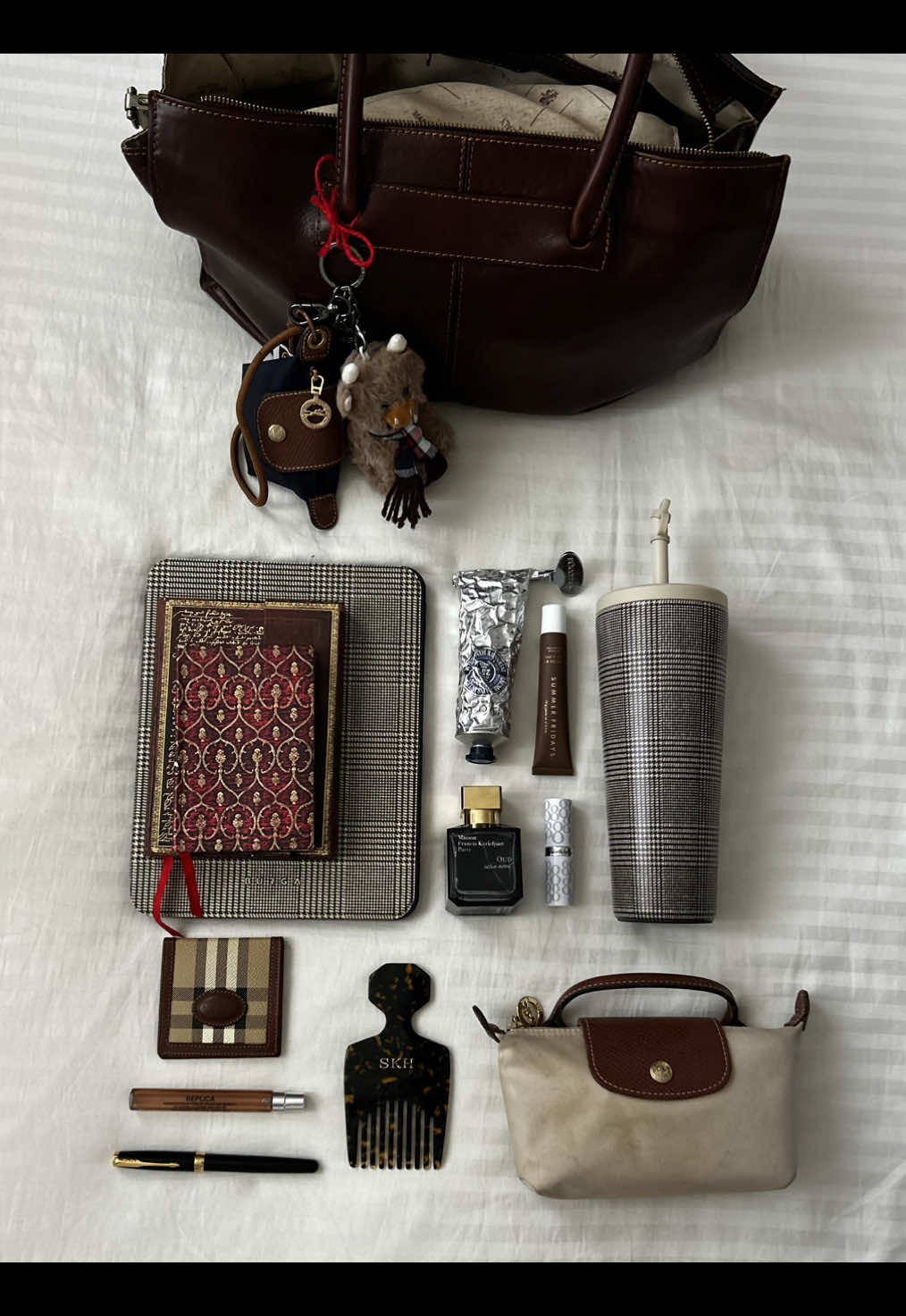 I could live out of my republic of florence handbag, and the essentials include:  - Gus the highland cow from @Islander UK (I love him sm)  - @BURGA matching iPad case and water bottle 🤎 - paperblanks journals x2 (obviously) - @L’Occitane Australia & NZ handcream (with me 24/7) - my signature scent combo of ‘Whispers in the Library’ by @maisonmargielafragrances and ‘Satin Mood oud’ by maison francis kurkdjian ✨ - lip combo of @Elizabeth Arden Inc. and @Summer Fridays  - my Parker pen (she is gorgeous)  - the emergency @Longchamp pouch (very woman needs one) - my officine universelle buly comb - my vintage @Burberry travel mirror (such a lifesaver)  What is one thing you can’t leave the house without! ✨🤎📖 #whatsinmybag #oldmoney #unistudent #darkacademia #pinterestaesthetic