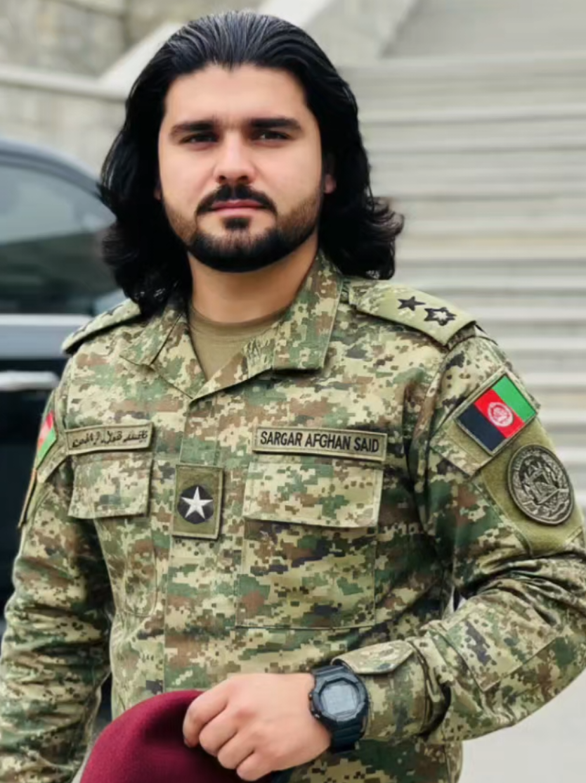 #afghanistan  #gilamnwazir  حپل عکسونه داسی جوړ کړی دعه انګلیس لیکنه کافی کړه هلته یی فوسټ کړی خپل نوم ورکړی زما نوم پر ځای Create a high-quality image of a young mar whose face and identity are 100% identica to his reference photo, wearing a full digita camouflage uniform of the Afghan army with rank insignia on his shoulders and a star on his chest, 
