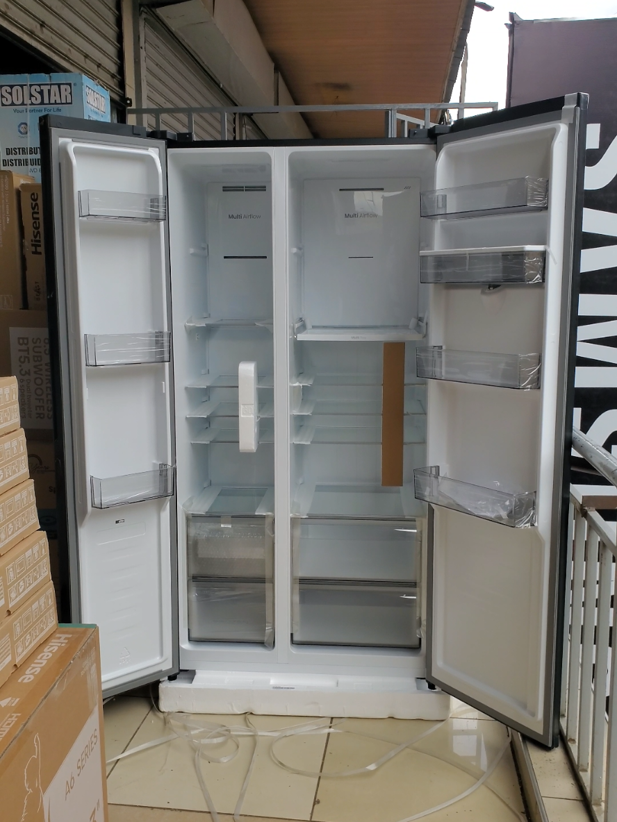 Hisense REF558DR is a 541L side-by-side refrigerator featuring a total frost-free cooling system and a built-in water dispenser. It is offered in a black mirror glass finish and a stainless steel finish, though availability may depend on the retailer. The fridge is energy-efficient and operates at a low noise level.  General specifications Capacity: 541 litres total, with approximately 341L in the fridge and 200L in the freezer. Dimensions: These may vary slightly by retailer, so confirm with the seller. Be sure to measure your kitchen and entryways to ensure a proper fit. Cooling technology: Multi-Airflow cooling ensures even temperature distribution to keep food fresher for longer. Energy efficiency: Rated A+ (based on some retailers), it is designed for low power consumption. It also features an eco mode to further reduce energy usage. Noise level: Operates at a quiet volume, typically under 40dB.  Special features Water dispenser: An external, non-plumbed dispenser provides chilled water from a refillable tank, increasing convenience and saving energy. Internal lighting: Bright, energy-efficient LED lights illuminate the interior. Control panel: A digital touch control panel allows for precise temperature adjustments without opening the door. Fast functions: Includes Super Cool and Fast Freezing functions for rapid cooling. Storage: Adjustable, spill-proof tempered glass shelves offer flexible storage. Dedicated drawers provide humidity control for fruits and vegetables. Voltage stabilization: Equipped to handle voltage fluctuations.  Design and finish Door finish: Available finishes include a black mirror glass door and a stainless steel look with an anti-fingerprint coating. Handle: Features a recessed handle design for a sleek, minimalist look. Door configuration: The side-by-side layout reduces cold air loss and improves visibility.                                                                                                       #hisense #hisenseperfectmatch #hisensefridge #refrigerator #kitchenappliances 