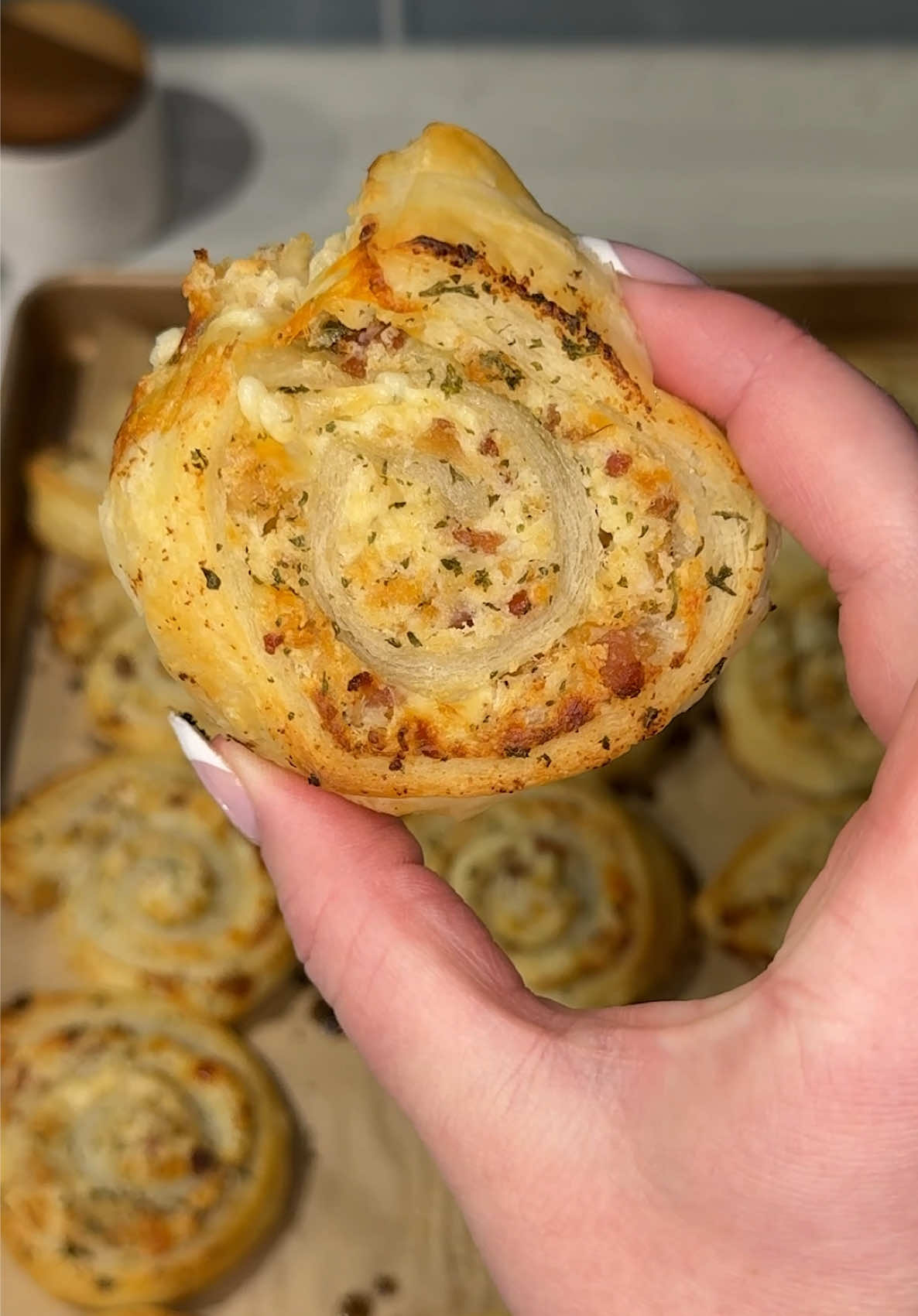 these chicken bacon ranch pinwheels are the golden, flaky, and cheesy little snackies you need to make every weekend 🧀🍗🥓 Ingredients: 1 sheet @JusRol North America puff pastry 6-8 frozen chicken nuggets (cooked and chopped) 4 oz (1/2 block) cream cheese (softened) ½ cup shredded mozzarella cheese ¼ cup bacon bits 2 tbs ranch dressing 1 tbs ranch seasoning mix 2 tbs butter (melted) ½ tsp garlic powder ½ tsp parsley flakes Instructions: In a large bowl, mix chicken, cream cheese, mozzarella, bacon bits, ranch dressing, and ranch seasoning until combined. Spread evenly on puff pastry, roll tightly, then freeze for 15–20 minutes. Slice into pinwheels, brush with melted butter mixed with garlic powder and parsley, and bake on a parchment-lined baking sheet at 400° for 12-15 minutes until golden. Serve warm and enjoy! 😋#creatorsearchinsights #Recipe #snack #EasyRecipe #cheese 