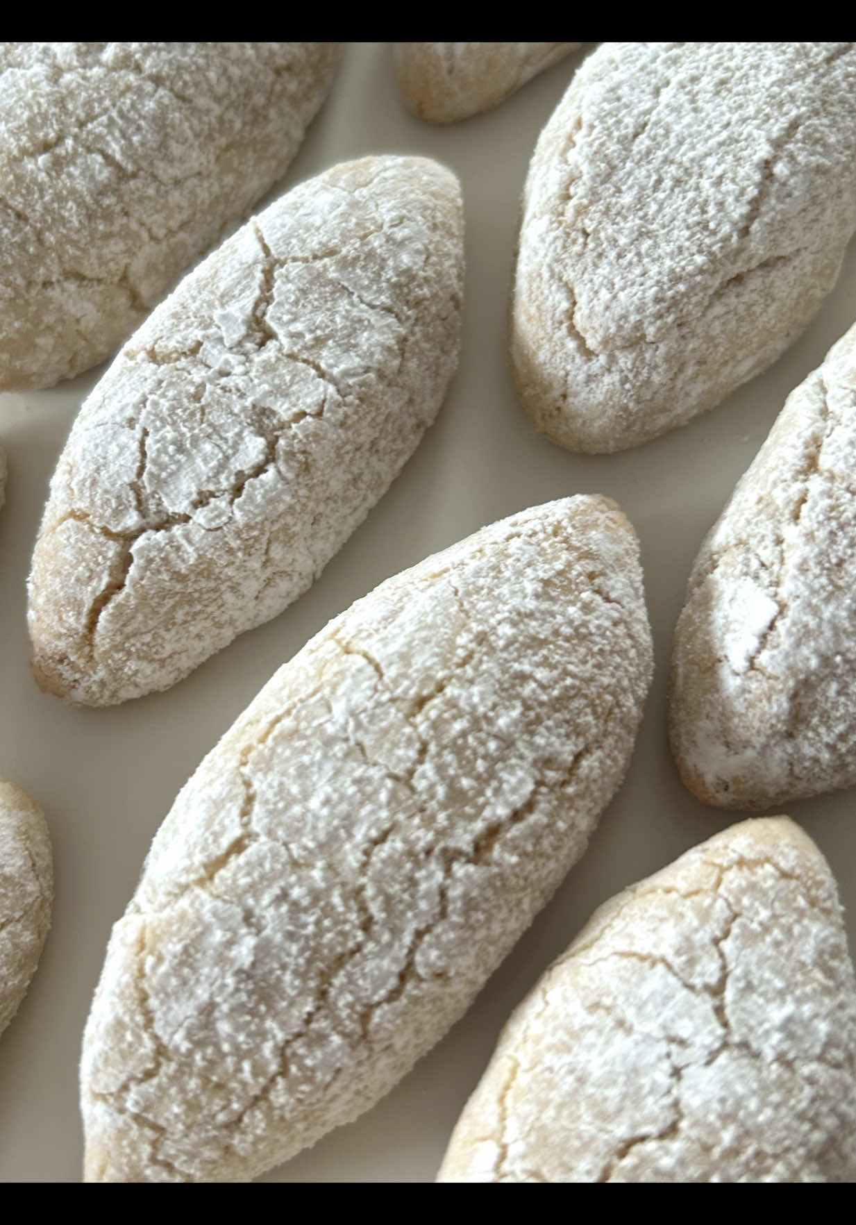 Ad | Ricciarelli Recipe 🤍 Ricciarelli are traditional Italian cookies from Tuscany, particularly popular in Siena! 🥰  📝 Ingredients :  (makes about 20 cookies) - 400 g ground almonds (blanched) - 150 g powdered sugar - 2 egg whites - 1 tsp lemon juice - 1 tsp vanilla extract (optional) - Powdered sugar for rolling and dusting 🤍 Instructions : 1. In a clean bowl, whisk the egg whites together with the lemon juice until stiff peaks form. Gradually add the powdered sugar while continuing to whisk until the mixture is smooth and glossy. 2. Gently fold the ground almonds into the egg white mixture. If desired, add the vanilla extract. 3. Using a tablespoon, scoop small portions of the dough and roll them in powdered sugar. Shape the portions into ovals and place them on a baking tray lined with parchment paper. 4. Preheat the oven to 160°C (top and bottom heat) and bake the cookies for 15-20 minutes, until they are lightly golden. They should remain soft in the center. 5. Remove the cookies from the oven and let them cool on a wire rack. Ricciarelli bring the authentic taste of Italy right to your home and are a delightful treat for special moments.🥰