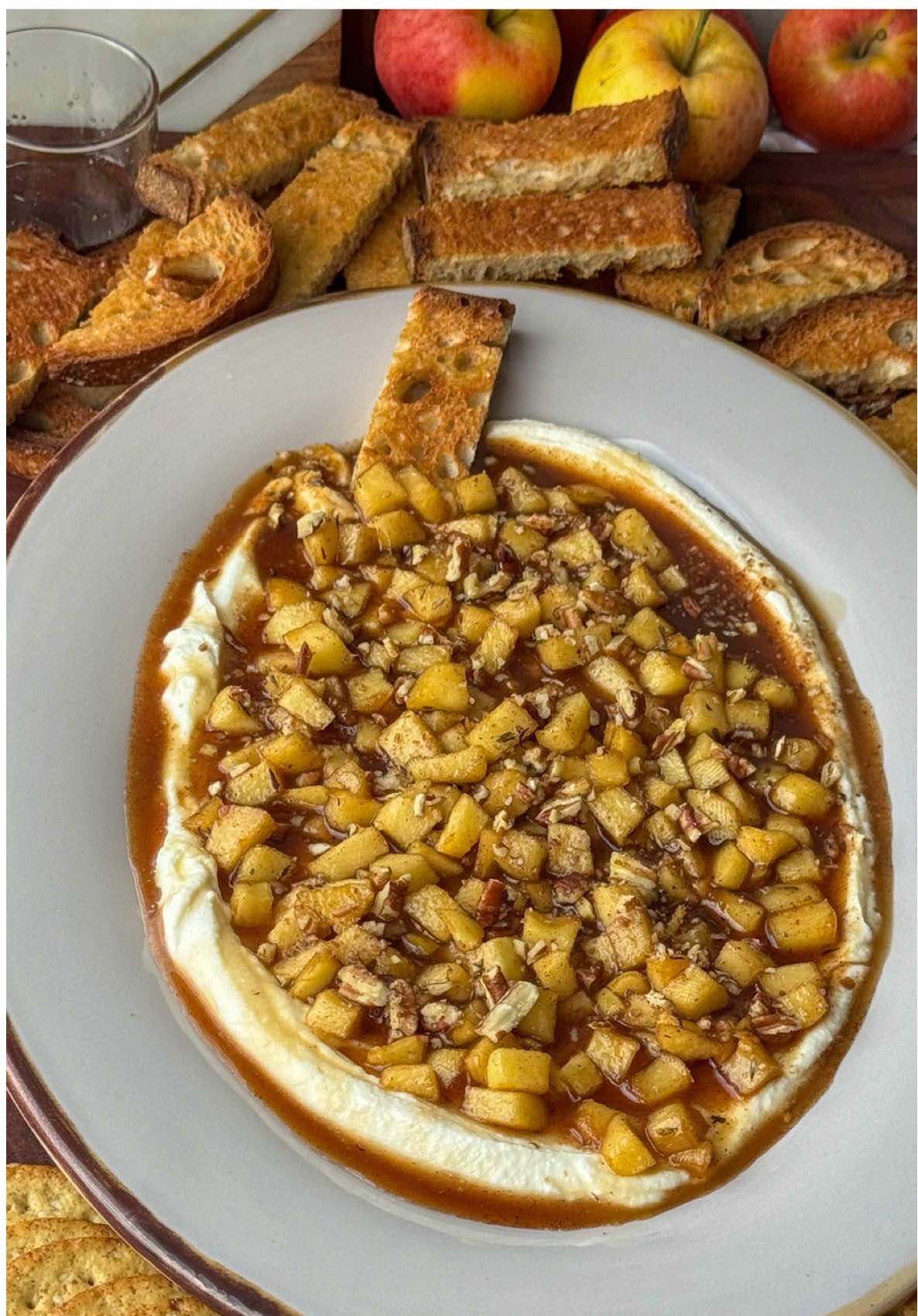 Whipped Ricotta with Caramelized Apples, Pecans & A Hot Honey Drizzle  A cozy bite of fall 🍎✨ If you came home from apple picking with more apples than you know what to do with, this is your sign — whipped ricotta with caramelized apples, pecans & hot honey. The easiest (and most impressive) appetizer for the holiday season! Serve with Crostini, crackers or toasted pita.  Caraway Exclusive 10%  Discount Code: EMANINTHEKITCHEN10 Discount Link: https://rstr.co/caraway/45164 —Whipped Ricotta Ingredients— 15oz whole milk Ricotta  2 tablespoons extra virgin olive oil  —Apple filling Ingredients— 2 large apples (peel and chop)  2 tablespoons unsalted butter  2 tablespoons brown sugar  2 tablespoons regular sugar  1 teaspoon vanilla extract  1/2 teaspoon cinnamon  1/4 teaspoon thyme (dried or fresh)  1/4 teaspoon salt  —Garnish— Hot honey (warmed) Pecans (chopped)  1. Add ricotta and olive oil to a food processor. Blend for 1–2 minutes, scraping down the sides as needed, until smooth, fluffy, and creamy. Set aside while you make the apples. (You can refrigerate)  2. Peel and chop 2 large apples into small diced pieces. 3. In a medium skillet over medium heat, melt the butter. Continue cooking, swirling with a wooden spoon occasionally, until the butter turns golden brown and smells nutty — about 2-3 minutes. 4. Add the chopped apples to the brown butter. Sprinkle in both sugars, vanilla extract, cinnamon, salt and thyme. Stir to coat the apples evenly.  5. Cook for 6–8 minutes, stirring occasionally, until the apples soften a bit and the sauce thickens and caramelizes. 6. Spoon the whipped ricotta onto a shallow bowl or serving plate, spreading it out evenly.  7. Top with the warm caramelized apples. 8. Sprinkle chopped pecans and a Drizzle of warm hot honey on top.  9. Serve immediately with crostini, crackers or toasted pita and enjoy!!!  #fallappetizers #whippedricotta #holidayseason #applelover #food 