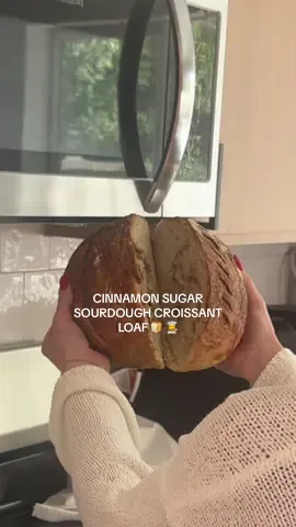 Kinda chaos but it turned out yummy! Ingredients:  Cinnamon sugar croissant sourdough roll  * 100 g active starter  * 350 g water  * 500 g bread flour  * 10 g salt  1. mix 100 g active starter with 350g room-temperature purified water, then add 500g bread flourand 10g salt until a shaggy dough forms. Cover and let it rest for 1 hour. 2. After resting, start your first set of stretch and folds—stretch and fold four times, turning the bowl each time. Place 1 stick of butter in the freezer while the dough rests for another 30 minutes. 3. Grate half of the frozen butter over the dough, spread it gently so it doesn’t melt, and sprinkle in brown sugar. Do another round of stretch and folds to start incorporating everything, then cover and rest 30 more minutes. 4. Grate the remaining half of the butter, spread it evenly on top. Perform another set of stretch and folds, cover, and let rest for 6–10 hours 5. Lightly flour your surface with rice or bread flour, then gently turn the dough out so it falls naturally without losing too many air bubbles. Shape it into a rectangle, add in brown sugar and pumpkin pie spice, fold the right side in, then the left, and roll it up from the bottom. Use gentle push-and-pull motions to form a smooth, round dough ball. 6. Flour a banneton basket with rice flour, place the dough inside seam-side up, dust the top lightly with flour, cover, and refrigerate overnight for a cold ferment. 7. The next day, preheat your oven to 500°F with your Dutch oven inside. Once preheated, remove the dough from the fridge, flip it out onto parchment paper with the smooth side facing up, dust with rice flour, and score your loaf however you like. 8. Carefully transfer the dough (using the parchment) into the hot Dutch oven, cover, and bake for 35 minutes. Then uncover and bake another 5-10 minutes until golden brown and crisp. Let it cool completely before slicing #sourdoughbread #cinnamonsugarcroissantloaf #sourdoughstepbystep #bread 