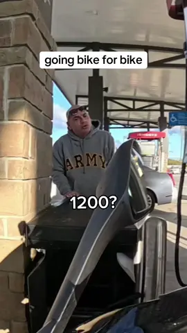 going bike for bike with a dude at a gas pump
