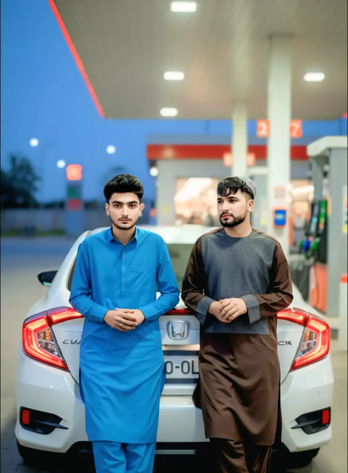 Match the first and second pictures. Both faces are looking into the camera. Both have their hands on the back of a Honda Civic. The faces and beards should not be changed.Merge thess pictures together. They casually leaning against the back of a white Honda Civic, which has subtle red accent lighting around its taillights.The setting is a gas station at dusk or night, with the pumps visible in the background, creating a slightly blurred, moody atmosphere with overhead lighting reflecting.#gemini #chatgpt #waliullahsahibzada #prompt #liveforthechallenge @ChatGPT @Gemini @Waliullah SAHIBZADA @TiktokPakistanOfficial 