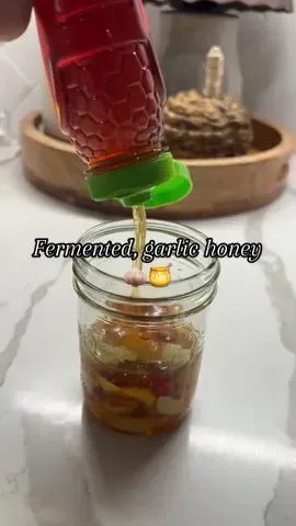 Welness Wednesday: Fill the jar W/ garlic (preferably organic), cover with honey!  Detailed benefits: 1. Immune Support: Both garlic and raw honey have antimicrobial & antiviral properties. Many people take a spoonful daily (or during cold/flu season) to help strengthen the immune system. 2. Cold & Sore Throat Relief: The honey soothes the throat, while the garlic can help fight off bacteria and viruses. 3. Digestive Health: Fermentation increases probiotics (beneficial bacteria) that support gut health. 4. Anti-Inflammatory Effects: Garlic contains compounds like allicin, and honey is rich in antioxidants, both of which help reduce inflammation. 5. Heart Health: Garlic may help lower blood pressure and cholesterol; honey supports healthy circulation. 6. Natural Energy Boost: The simple sugars in honey provide quick energy, while garlic supports better blood flow. #crunchy #crunchymom #homeremedy #nontoxic #MomsofTikTok