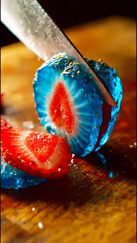 realistic 4K footage close-up of a knife rapidly cutting a blue glass strawberry on a wooden cutting board. It slices it multiple times, each slice fallsstrawberrtmy over as the knife moves to the next. The inside of the fruit is also glass. The sound is ASMR style. #strowberry #imazighn_chloh_ntiktok #agadir_morocco #ai # #strawberryshortcake 