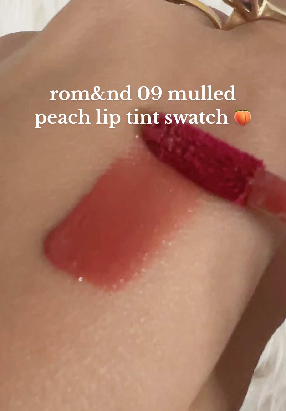swatching the juicy lasting tint by rom&nd in 09 mulled peach (flash + no flash) 🍑 it’s mostly a flush of color on the lips and not as pigmented as the swatch but is buildable 💗 #liptint #makeup #peach #romand #lips 