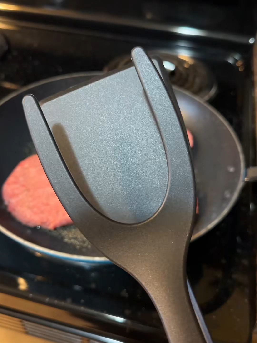 No more juggling tools! One utensil does the work of two at the grill.