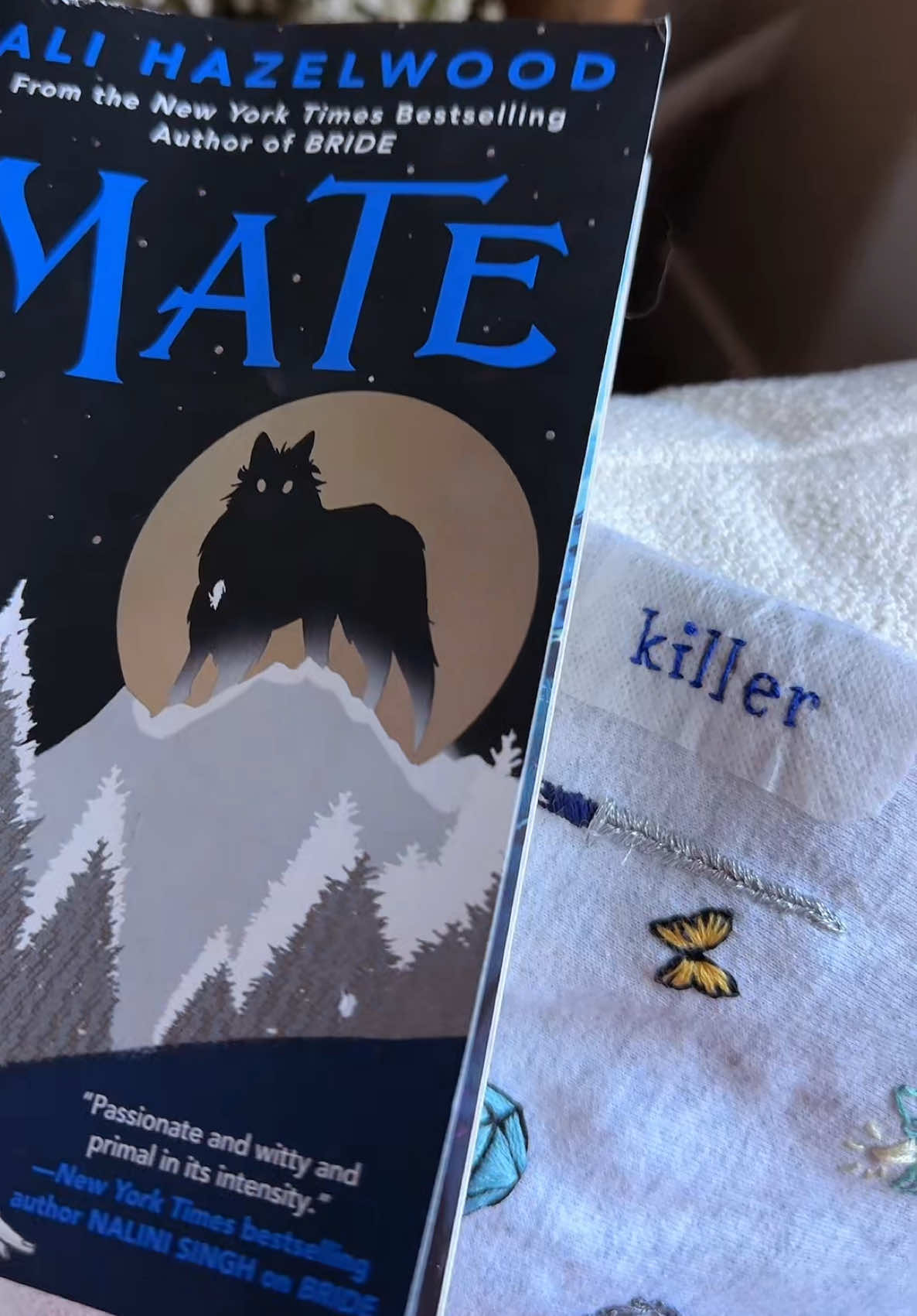 Ali Hazelwood does it again!!!  I LOVED Bride and I’ve been looking forward to Mate for so long and it did not disappoint!  This book had me laughing pretty much the whole time while simultaneously making me cry and ripping my heart out and making me so unbelievably happy.  The light hearted banter that Serena and Koen had throughout was so heartwarming amidst all the crazy mystery and cult business. The spice was SPICY but the romance and the YEARNING?!? The way this man yearns. His small snippets at the beginning of each chapter were AMAZING. I’m so sad this is over but I’m just so excited to see what Ali does next. When it comes to paranormal romance, even though it’s not her typical “niche” per se I think she has so much talent to take this even farther. The omegaverse that she has set up could create so many other stories and I will absolutely read them all.  ⭐️⭐️⭐️⭐️⭐️ #booksweatshirt #embroidery #cozyhobbies #bookembroidery #alihazelwood 