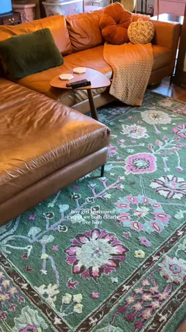 a pop of pink and florals to break up all of the brown in here! next up: new throw pillows 👀 (also every box in the background is my christmas decor that will be going up nov. 1!!!) #apartmentdecor #boygirlapartment 