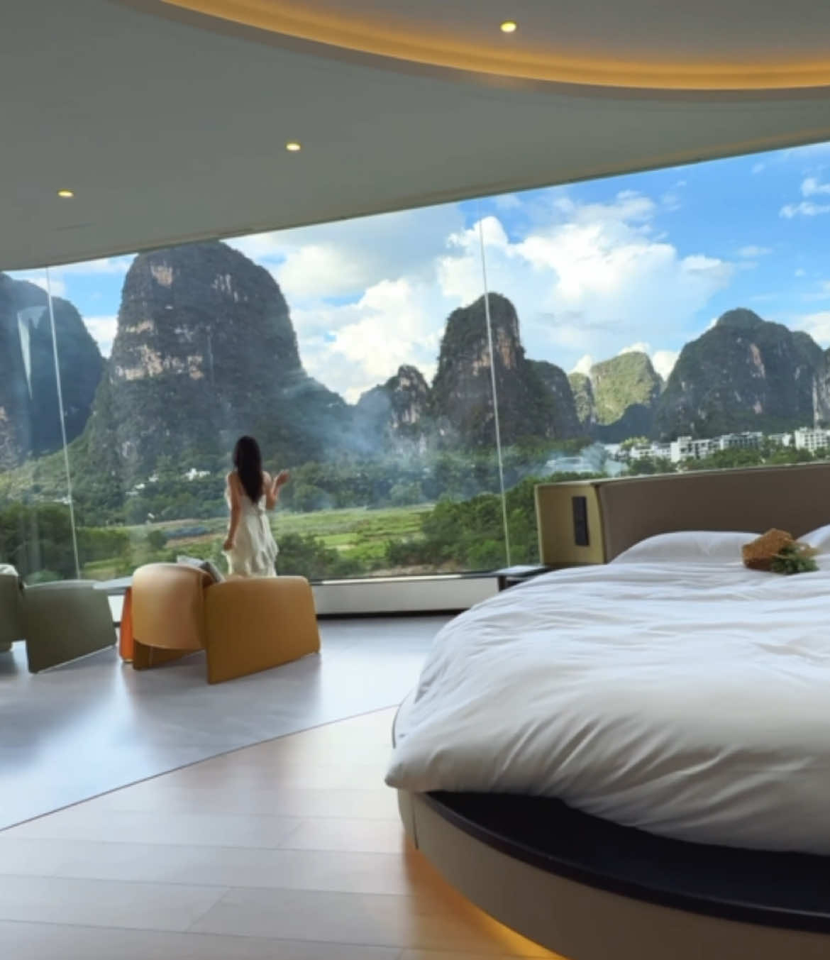 Standing by the window, wrapped in shades of green.