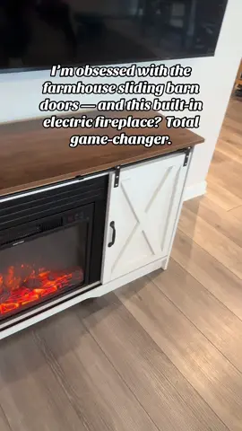 I’m obsessed with the farmhouse sliding barn doors — and this built-in electric fireplace? Total game-changer. Warm up your home with the perfect blend of style and function — the HOMBCK Fireplace TV Stand combines a modern farmhouse look with a realistic 23” electric fireplace insert. It’s not just furniture — it’s a whole mood. Enjoy adjustable storage, sliding barn doors, and a sleek TV console that makes your living room feel inviting, stylish, and totally on trend. 	•	Built-in 23” Electric Fireplace: Adds warmth and ambiance at the touch of a button — no venting or mess required. 	•	Farmhouse Sliding Barn Doors: Classic rustic charm meets modern design for a timeless look. 	•	Adjustable Storage Cabinets: Perfect for organizing decor, electronics, or media accessories. Add to cart before these sell out — cozy season is calling, and turn your home into your happy place — start with this fireplace TV stand. #HomeDecorFinds #FireplaceAesthetic #FarmhouseStyle #CozyHomeVibes #HOMBCK
