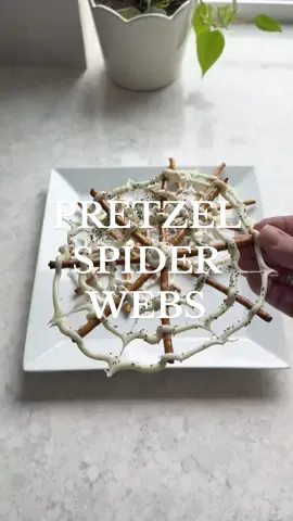The easiest Halloween treat ever - just pretzels and white chocolate! So simple, spooky, and kid-approved, these little spiderwebs make the perfect Halloween snack! SAVE this idea + SHARE with your Halloween loving friends! 