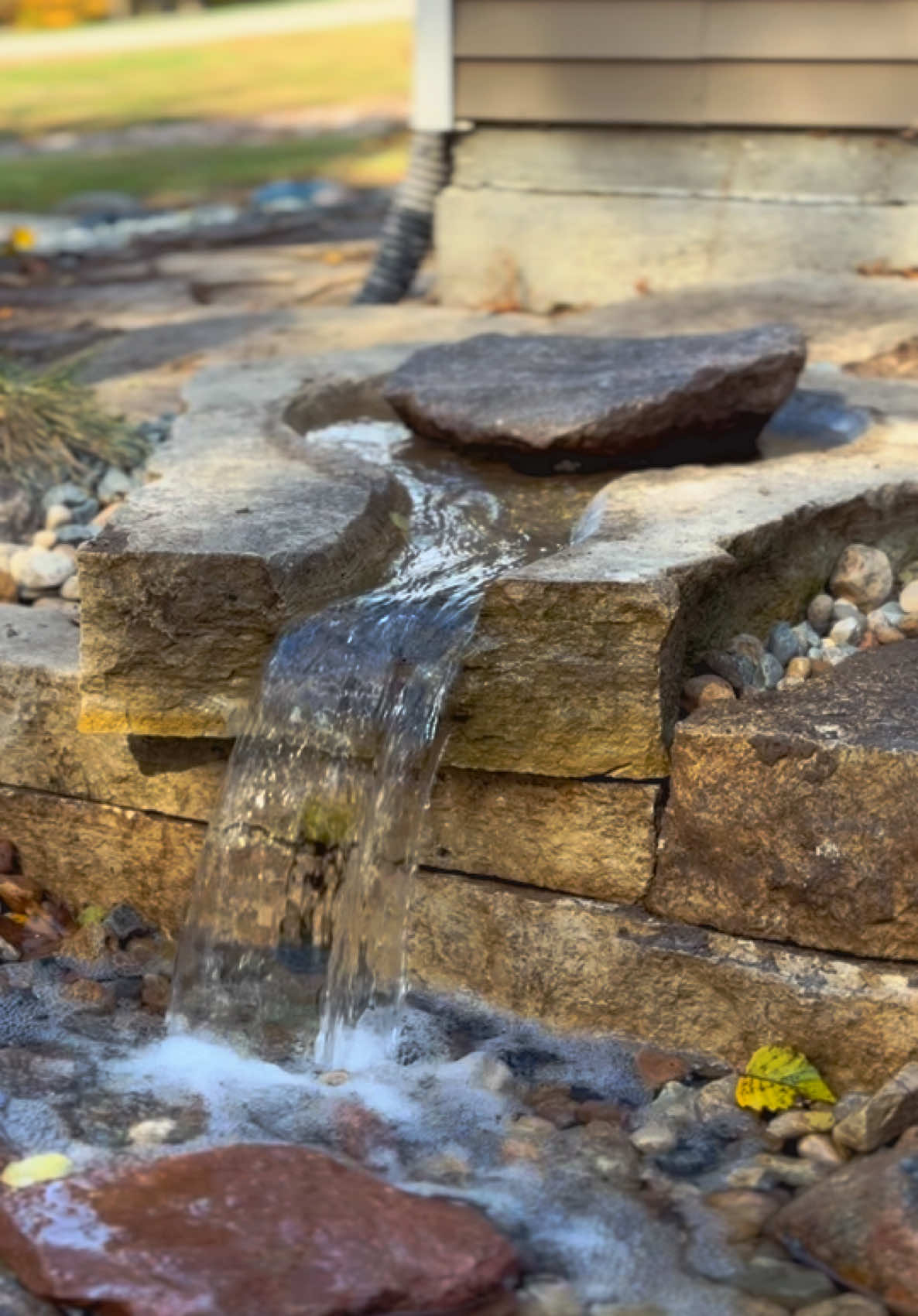 Bringing it back to life 🤩 Have an old water feature that you loved but it needs some new life? We can repurpose special rocks or fountains in our design.  Just look at this neat fountain rock we were able to incorporate into this renovation project! #iowa #desmoines #waterfall #pond #outdoorliving   