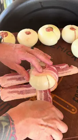 Bacon Wrapped Cheesy Onion Bombs Get yourself 6 large sweet onions (I prefer Vidalia) Cut them in half thru the core and then peal out the inner layers leaving only the thick outer layer. In a bowl mix 1 lb ground beef (I used K4 Gourmet Beef) 1 cup shredded cheese (I used white cheddar) 1 teaspoon black pepper 1 teaspoon salt 1 teaspoon smoked paprika  1 teaspoon garlic powder 1/2 cup Italian bread crumbs  1 egg Mix well but be careful not to over mix  Form into medium sized meatballs. You want to match the size of the onion to judge it on a nice snug fit. Pair the matching onion half so that it seals up real good. Wrap with 3-4 pieces of bacon. Brush with your favorite BBQ sauce and dust with your favorite rub. For mine I used SPG. Place them on a try lined with foil or butcher paper and then into the smoker (or oven) for 45 min at 350 degrees. When the sauce starts to candy up they are ready to go. Let them sit for 10 min before serving.  Enjoy! #bacon #outdoorcooking #smoker #jesus @Weber Grills @K4Ranches 
