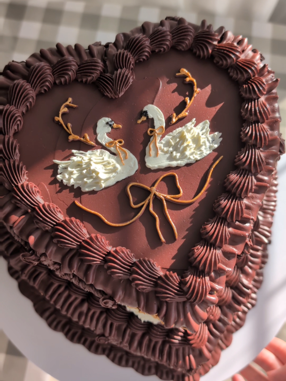 Found these swan stamps on Vinted and they're amazing, especially as someone who struggles with and is working on symmetry! just sad I didn't get any footage piping them 🫠 🦢 Inspo for this cake was an @Anthropologie advert that kept popping up for an @Elizabeth Scarlett  bag! 🦢 🍰 this is a dummy cake for me to practice ideas on, so ignore any bits of polystyrene peeping through!  #caketok #wiltoncakes #cakedecorating #vintagecake 