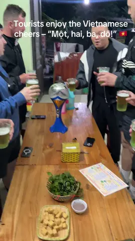 Tourists enjoy the Vietnamese cheers – “Một, hai, ba, dô!” 🇻🇳 #HaGiangLoop #VietnamCulture #BeerCheers #MotHaiBaZo #TravelVietnam     