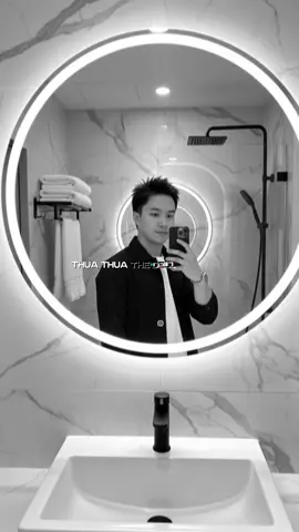 1. Open Gemini 📱 2. Upload portrait photo📸 3. Paste prompt:👇🏻 A hyper-realistic cinematic 9:16 portrait based on the uploaded image, keeping the same face and hairstyle of A confident man taking a mirror selfie in a sleek, modern bathroom. He wears a black jacket layered over a crisp white t-shirt and a stylish wristwatch. The bathroom features a circular, backlit mirror glowing with soft white light, mounted on a marble-patterned wall with elegant grey veining. Below the mirror, a white rectangular sink with a matte black faucet sits on a minimalist counter. To the side, a towel rack holds neatly folded white towels, and a hanging towel adds a touch of realism. A matte black rainfall showerhead is visible in the background. The lighting is bright and evenly distributed, casting soft shadows and enhancing the clean, contemporary aesthetic. The image is rendered in ultra-realistic 8K resolution, with hyper-detailed textures #gemini #trending #fyp #xuhuong #viral