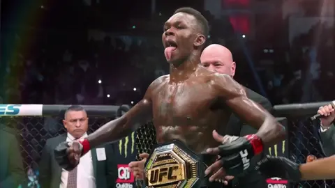 Israel Adesanya — full name Israel Mobolaji Odunayo Oluwafemi Temitayo Owolabi Adesanya — is a Nigerian-born New Zealand mixed martial artist, kickboxer, and former UFC Middleweight Champion. #israeladesanya #thelastairbender #ufs #prime #boxing  Here’s a full profile: ⸻ 🥋 Basic Info 	•	Nickname: The Last Stylebender 	•	Born: July 22, 1989 (Lagos, Nigeria) 	•	Nationality: Nigerian–New Zealander 	•	Height: 6′4″ (193 cm) 	•	Reach: 80″ (203 cm) 	•	Weight Class: Middleweight (185 lbs), has also competed at Light Heavyweight (205 lbs) 	•	Fighting Out Of: Auckland, New Zealand (City Kickboxing) 	•	Team: City Kickboxing (with teammates like Alexander Volkanovski and Dan Hooker) ⸻ 🏆 Career Highlights 	•	Former UFC Middleweight Champion (2x) 	•	Professional MMA Record: 24 wins – 3 losses (as of 2025) 	•	Kickboxing Record: 75 wins – 5 losses 	•	Notable Wins: Robert Whittaker, Anderson Silva, Paulo Costa, Jared Cannonier, Marvin Vettori, Alex Pereira (rematch) 	•	UFC Debut: February 2018 — defeated Rob Wilkinson via TKO ⸻ ⚔️ Fighting Style 	•	Elite striking and movement, with a background in kickboxing and Muay Thai 	•	Known for feints, distance control, counterstriking, and precision 	•	Exceptional fight IQ and composure in the octagon 	•	Uses a lot of anime-inspired flair and symbolism — hence the nickname The Last Stylebender (a reference to Avatar: The Last Airbender) ⸻ 🎭 Personality & Legacy 	•	One of the most charismatic and marketable UFC stars 	•	Famous for his creative walkouts, anime references, and showmanship 	•	Advocates for mental health awareness and African representation in MMA 	•	Regarded as one of the best strikers in UFC history