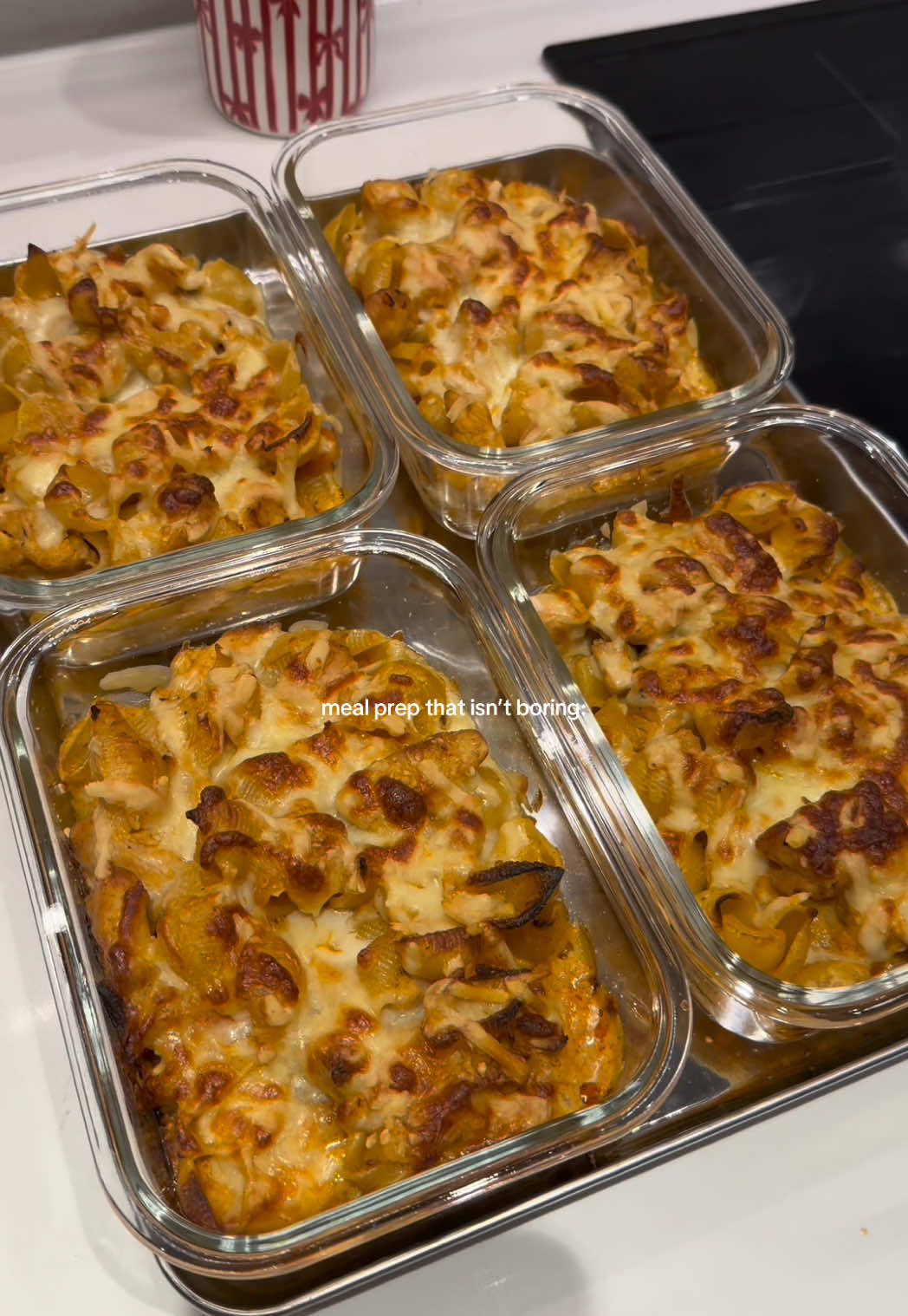 pesto chicken pasta bake 🤤 Ingredients (serves 4): 3-4 chicken breasts, chopped 1 tsp smoked paprika 1 tsp garlic powder Pinch of salt and pepper  3 garlic cloves, diced 1 white onion, diced 1 red pepper, diced 1 yellow pepper, diced  100g red pesto 200g low fat soft cheese 320g dry weight pasta  + 2 large spoonfuls pasta water  Grated cheddar Grated mozzarella  Firstly, chop up all your veggies and chicken. Then season your chicken in the smoked paprika, garlic powder, salt and pepper. Fry off your chicken in a large pan until sealed. Then add your garlic, onion and pepper and cook until softened. Pop your pasta onto boil as per instructions and turn your oven to 180 degrees C.  Add your red pesto to the pan, give a good stir, then add your soft cheese and mix until combined. Then add a few spoonfuls of pasta water, let simmer until a sauce forms. Add your pasta and mix well.  Divide your pasta into glass, oven safe containers (or just one big dish), then add your cheeses and bake in the oven for 25 mins until the cheese has melted and is golden.  #pestopastabake #mealprepideas #mealprep #chickenpestopasta #highproteinmeals 