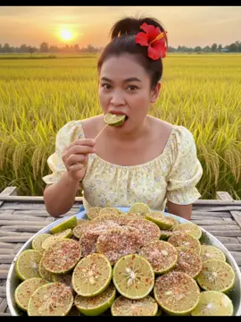 #aiสร้างภาพ #สร้างภาพai #aiสร้างรูปตลกๆ #แจกคำสั่งgimini #แจกpromptฟรี  prompt : สร้างภาพจากรูปที่แนบมา ใบหน้าเหมือนเดิม100% ห้ามแก้ไข สวมเสื้อปาดไหล่สีเหลืองอ่อนแขนตุ๊กตาลายดอก ไม้เล็กๆ มัดผมหางม้าสูง ติดกิ๊บรูปดอก ชบาสีแดงที่โคนผม เธอนั่งอยูบนเถียงนา นั่งหลังจานมะนาวคลุกพริกเกลือจานใหญ่ยักษ์ มะนาวคลุกพริกเกลือ รสชาติจัดจ้าน โฟกัสให้เห็นเนื้อในสีขาวนวลที่เรียกว่า แกน (pith) และเนื้อสี เหลืองอ่อน คลุกเคล้ากับส่วนผสมของพริกเกลือซึ่งประกอบด้วย พริกป่น เกลือ น้ำตาล ทราย เพื่อให้ได้รสชาติเปรี้ยว เค็ม เผ็ด และ หวานกลมกล่อม ผู้หญิงในภาพกำลังใช้ไม้จิ้มลูกมะ นาวหั่นครึ่งที่เคลือบด้วยพริกเกลือเข้าปาก ท่ามกลางบรรยากาศทุ่งนา ข้าวกำลังออกรวงเหลืองใกล้เกี่ยวข้าว บรรยากาศมองเห็นดวงตะวันกำลังตกดิน ภาพสมจริงเสมือนถ่ายโฆษณา ถ่ายภาพระยะใกล้ สัดส่วนภาพ9:16