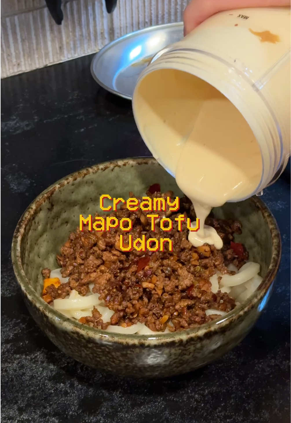 RECIPE BELOW (Shoutout @Audrey Lin for one of the best meals I’ve made recently) Ground Beef, or Pork Silken Tofu Udon Noodle Garlic  Scallion Tofu Cream Sauce (No need to cook): - 1/2 block of Silken Tofu - 1/2 Tbsp of Miso (Optional but not recommended) - 1/2 Tbsp of Peanut Butter (Optional) Minced Beef Sauce:  - 1 Tbsp Doubanjiang - 1/2 Tbsp Chili Crisp - Chinese Cooking Wine - Black Vinegar  - Sugar - Pinch of Salt  - Pinch of MSG 1. Mince garlic and slice white part of the scallion 2. Heat oil in a wok and cook ground beef, or pork, until brown. Remove and set aside.  3. In the same wok, add garlic, white scallion, doubanjiang, and chili crisp and cook. Sauté until fragrant 4. Deglaze with cooking wine and black vinegar to the wok, then add the meat back to the wok. Stir-fry until everything’s well combined 5. In a blender, add silken tofu, miso (optional), and peanut butter. Blend until everything is smooth and creamy 6. Cook udon according to package 7. Assemble -> Udon first, then spoon over the ground meat, and finally pour over the creamy tofu mixture 8. Top with scallions 9. Mix and enjoy #creamyudon #udonrecipe #mapotofu #easydinnerideas