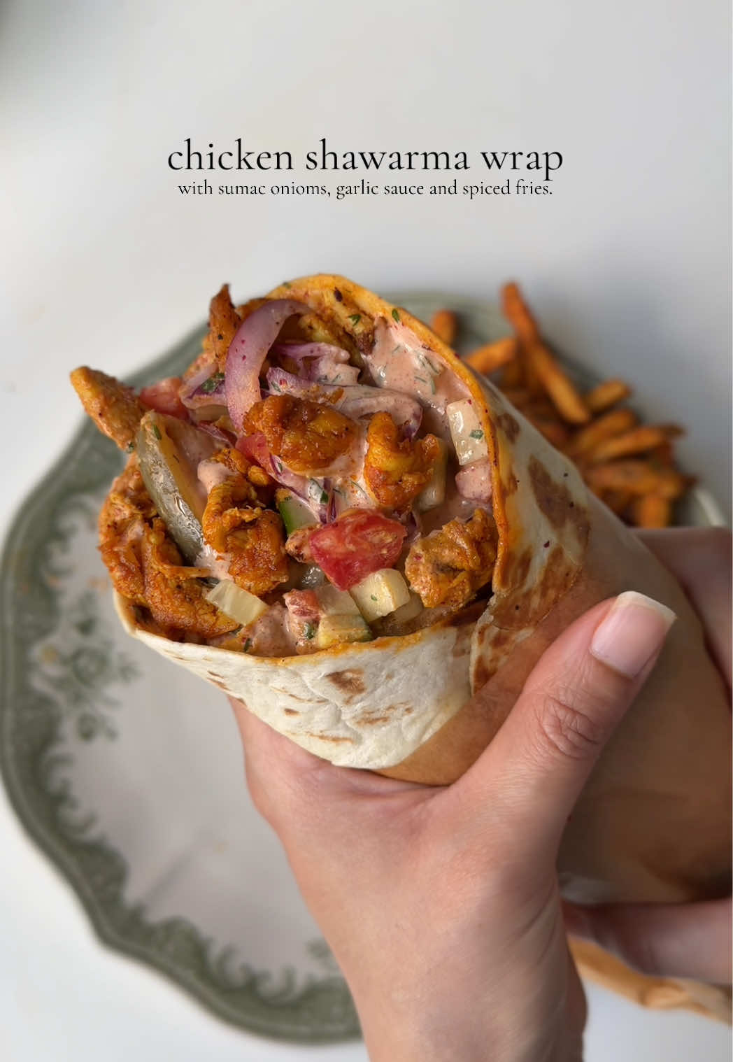 Chicken shawarma wrap 🌯 Ingredients  For the chicken: 2 lb boneless chicken breast/ thighs, cut into thin slices  1 tbsp fresh garlic, finely minced  2 tbsp mayonnaise  1 tbsp olive oil 1 tbsp smoked paprika powder  1 tsp garlic powder  1 tsp black pepper powder  1/2 tsp cumin powder  1/2 tsp coriander powder  1 tsp red chili powder  1/2 tsp turmeric powder  Salt to taste 1 tbsp fresh lemon juice  3 tbsp clarified butter/oil for cooking  For the sumac onions 1 large red onion, thinly sliced and washed  1 tbsp fresh parsley, chopped  1 tbsp sumac  1 tsp lemon juice  Salt to taste For the garlic sauce : 1/3 cup mayonnaise  1/3 cup sour cream 3-4 tbsp butter milk ( less or more to adjust the consistency of the sauce ) 2 tbsp ketchup  2 tbsp hot sauce  1 tsp freshly chopped parsley  1 tsp lemon juice  1 tbsp garlic powder  1 tbsp smoked paprika powder  Salt to taste 1/2 tsp black pepper  To assemble: 6 tortilla wraps 1/2 cup cucumber, chopped  1/2 cup tomatoes, chopped  Spiced French fries 1/2 cup pickled cucumbers  Method: In a mixing bowl add chicken, season with salt, pepper, garlic powder, smoked paprika powder, turmeric, red chili powder. Add in the mayonnaise, garlic, oil and lemon juice. Mix until well combined. Cover and let it marinate for at-least 1 hour. Prepare the sauce by mixing mayonnaise, sour cream, buttermilk, salt pepper, paprika powder, garlic powder, hot sauce, lemon juice, ketchup in a bowl. Whisk until smooth and creamy.  Make the sumac onions by mixing onions, parsley , sumac, salt lemon juice in bowl. In a pan, heat clarified butter over medium heat. Once melted, add the chicken and cook in batches, ensuring not to overcrowd the pan. Cook for about 8-10 minutes, tossing occasionally, until the chicken is fully cooked through. Assemble the wrap by warming the tortilla, then adding sauce, Sumac onions, chicken, tomatoes, cucumber, pickled cucumbers, French fries, and more sauce. Close it and serve one. #chickenwrap #Recipe #shawarma 