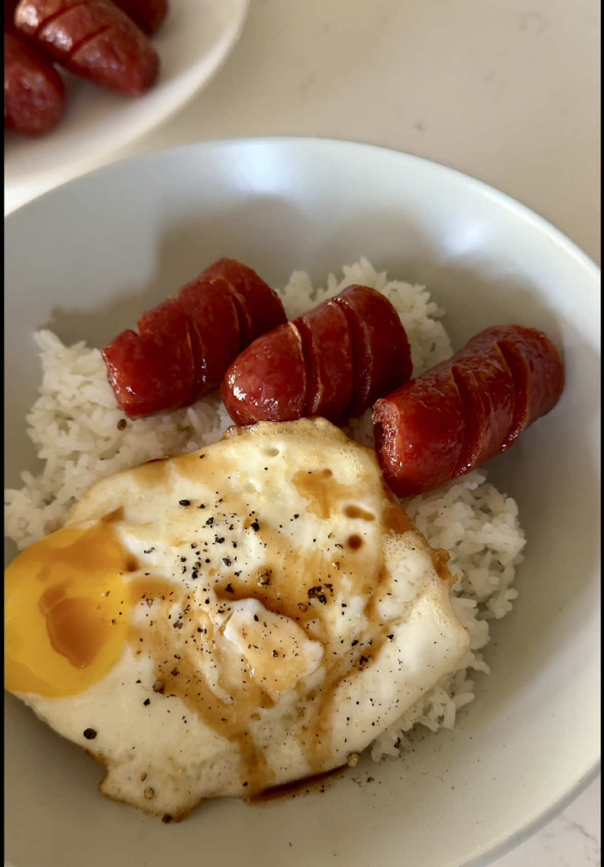 Chinese sausage, eggs and rice - so simple and one of my favorite go to meals!  1 package of Chinese sausage (my fav brand is California Sausage) Eggs Oil/Butter for cooking  Knorr seasoning sauce, Mountain Soy Soy, Maggie Sauce or regular Soy Sauce  Boil the Chinese sausage for 20 minutes. Cut slits in the sausage then air fry at 350 degrees for about 3 minutes per side or until crispy. Cooks eggs to your liking then serve with steamed rice.  #EasyRecipes #chinesesausage #recipes 
