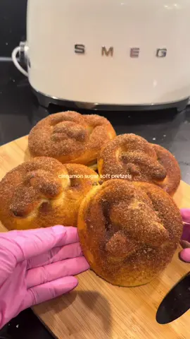 Recipe : 🥨 Cinnamon Sugar Soft Pretzels Ingredients For the dough: 1 ½ cups warm milk (about 40°C / 105°F) 7 g active dry yeast (1 packet) 1 tsp salt 2 tbsp brown sugar 2 tbsp unsalted butter, melted 4 cups bread flour For the bicarbonate wash: 3 L boiling water 1 tbsp baking soda For topping: 2 tbsp melted butter (for brushing) ½ cup granulated sugar 1 tbsp ground cinnamon Milk or egg wash (for brushing before baking) Instructions: Activate the yeast: Pour the warm milk into a mixing bowl. Sprinkle in the yeast, stir gently, and let it sit for 5–10 minutes until frothy. Make the dough: Add salt, brown sugar, and melted butter to the milk mixture. Mix to combine. Gradually add the bread flour, mixing until a dough forms. Knead the dough: Transfer to a floured surface and knead for about 8–10 minutes, until the dough is smooth and slightly tacky (not sticky). First rise: Shape the dough into a ball, place it in a lightly greased bowl, cover with a towel or plastic wrap, and let it rise for 1–2 hours or until doubled in size. Shape the pretzels: Punch down the dough and divide it into 8 equal pieces. Roll each piece into a long rope and shape into a pretzel. Prepare the bicarbonate wash: Bring 3 L of water to a boil and add 1 tbsp baking soda. Carefully dip each pretzel into the boiling water for about 20–30 seconds, then remove and place on a baking sheet lined with parchment paper. Bake: Brush each pretzel with milk or an egg wash. Bake at 230°C (450°F) for 12 minutes, or until golden brown. Finish with cinnamon sugar: While warm, brush the pretzels with melted butter. Mix cinnamon and sugar together, then coat each pretzel generously. #pretzels #FoodTok #baking #viral #cinnamon 