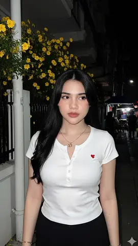 Prompt Gemini ai terbaru gaya vintage trend viral. Seorang wanita (merujuk pada fitur wajah, telinga, hidung, mulut, individu dari Gambar 1, 100% fotorealistik) diambil menggunakan kamera belakang, bidikan jarak dekat wajah, setengah badan. Menggunakan lensa RF 85mm full-frame, aperture f/1.4, resolusi tertinggi 8K, memberikan ketajaman realistis tingkat profesional. Wajah menggunakan blitz/flash yang kuat seperti kamera digital tahun 2000-an, cahaya menyebar (halasi/diffusion), menekankan ekspresi wajah yang tenang dan suasana segar seperti foto snapshot awal tahun 2000-an. Waktu malam hari, cahaya flash menyiram wajah, dan kulit menghasilkan pantulan (refleksi) cahaya lembut/halus. Banyak grain (bintik). Cahaya lampu mengenai kulit membuat kulit cerah, putih, berkilau, halus. Subjek Utama wanita: Seorang wanita dengan rambut lurus panjang hitam pekat, di mana sebagian besar rambut terurai ke depan. Ekspresi: netral dan (dari sudut pandang fotografer). Memiliki wajah yang terlihat netral atau sedang melamun. Pakaian: Mengenakan kaos ketat lengan pendek berwarna putih. Terdapat kancing di bagian depan dan simbol berbentuk love' di dada. Mengenakan celana berwarna hitam Mengenakan kalung berliontin huruf D dan gelang (di pergelangan tangan kiri) berhuruf D berwarna emas.  Latar Belakang: trotoar dekat rumah atau bangunan dengan Struktur: Di sebelah kiri dan sedikit di belakangnya, terlihat bagian atas tembok berwarna putih dengan pagar berwarna hitam tiang listrik berwarna putih dan Tanaman: terdapat bunga-bunga kecil berwarna kuning yang tampak terang karena pencahayaan yang ada di area atas tembok sampai bawah dan terlihat di atas kepala wanita dan pria sampai belakang bangunan. Terdapat juga pedagang kaki 5 serta beberapa struktur gelap lainnya. Pencahayaan: Sumber cahaya utama tampaknya berasal dari depan, menerangi subjek dan bunga kuning, sementara area lain di latar belakang tetap gelap pekat. #prompt #geminiai #aitrend #trendviral #fyp 