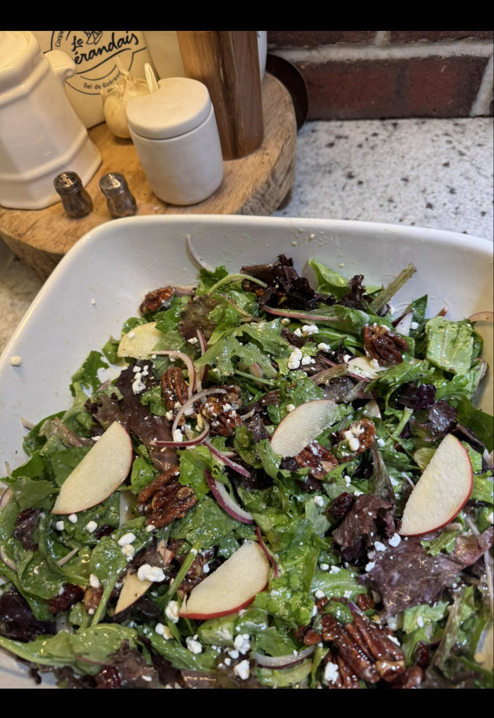 Day 2 of my Thanksgiving Series… the perfect Autumn Salad🍎🍂 No need to look any further for a salad recipe to take to your next party!  Ingredients: •10 oz container spring mix •1/2 of a medium sized •red onion •4 oz container goat cheese crumbles •5 oz bag of cranberries •1-2 honey crisp apples •8 oz bag of halved pecans •1 tbsp butter •1/4 cup packed brown sugar •1/2 tsp cinnamon •2 tbsp water Dressing: •1/2 cup olive oil •1/3 cup white wine vinegar •3.5 tbsp maple syrup •1.5 tbsp Dijon •1 1/4 tsp garlic salt •3/4 tsp pepper Start by candying your pecans. With the heat off put the butter, cinnamon, brown sugar, and water into your pan. Then turn the heat to medium. Stir while that melts, then when it starts to boil/bubble, pour in your pecans. Leave the heat on. Stir constantly or every 10 seconds until the pecans suck up all the sugar mixture, roughly 4ish minutes. Take it off the heat and pour onto some parchment paper and let cool.  Cut your apple and red onion into thin slices. Mix the ingredients of your dressing. Assemble the salad and you’re done!! #EasyRecipes #saladrecipe #healthyeating #thanksgivingseries #thanksgivingfood #sidedish #thanksgiving #holidayrecipes #autumn #cozy #christmas #hosting #holidaycooking 