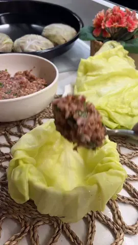 PER PORTION STUFFED CABBAGE Ingredients: 250g ground meat 1.5 tea cups parboiled rice 2 21 onions Quarter bunch parsley 1 tablespoon tomato paste 1 teaspoon mint 1 teaspoon red pepper flakes Salt Half a tea cup vegetable oil Cabbage For the sauce: 1.5 tablespoons tomato paste (you can use mixed peppers) 1.5 cups water 2 tablespoons vegetable oil Salt Instructions: Boil the cabbage. Set aside the remaining ingredients; | made mixed pickles. For the filling, combine all the ingredients in a bowl and mix them. Place the cabbage in the bowl. Add 2 heaping tablespoons of the filling, cover, and turn the cabbage upside down. Arrange on a baking sheet. For the sauce, heat oil in a pan and sauté the tomato paste. Add water and salt, and stir. Do not eat, just spread on top. Cover the edges tightly with wet wax paper and bake in a 190°C oven until golden brown. Enjoy! #treding #yummyfood #homemadefood #meat #sarmale 