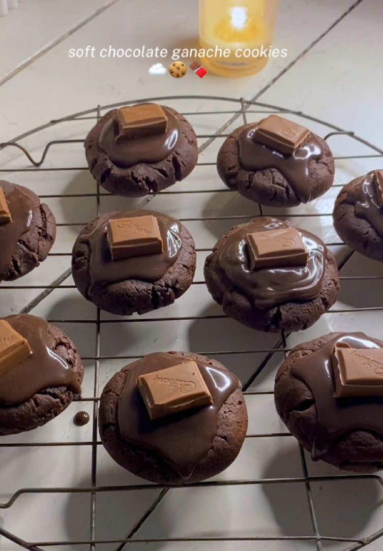 A little chocolate heaven 🍫☁️ Soft cookies with melty chocolate. They taste even better when you use the chocolate bar you love 🤎.  (Recipe down below) Surga coklat sih ini 🍫🤍 Cookiesnya lembut dengan ganache-nya yang lumer. Kamu bisa pake merek coklat batangan yang kamu suka utk hasil yang lebih sesuai selera, bisa delfi, sliverqueen, colatta, dll 🫶🏻. Inspired by @Poppy | Baking and Recipes ‘s recipe but I adjusted a few things to fit what I had 🤍 Ingredients / Bahan 135g all purpose flour (≈ 1 cup + 1 tbsp) / tepung terigu serbaguna 38g cocoa powder (≈ ⅓ cup) / bubuk coklat 2g instant coffee (≈ ½ tsp) / kopi instan (buat rasa coklat lebih deep) ½ tsp baking soda ½ tsp salt / garam 85g salted butter, softened (≈ 6 tbsp / ⅓ cup) / butter salted suhu ruang 65g light brown sugar (≈ ⅓ cup)  25g granulated sugar, blended (≈ 2 tbsp) / gula pasir, diblender 1 small egg or ± ¾ medium egg (≈ 38–42g, about 2½ tbsp) / 1 telur kecil atau 3/4 ukuran medium 1 tsp vanilla extract 1 tbsp honey (optional for chewiness) / madu (opsional, gapake gapapa) Ganache Topping 57g chocolate (≈ ⅓ cup chopped) / coklat batang, cincang kecil 50g whipping cream (≈ 3 tbsp) / whip cream cair Directions / Cara 1. Cream the butter, brown sugar, and granulated sugar just until combined. Kocok butter + gula sampai tercampur lembut, gausah sampe ngembang / terlalu pucat.  2. Add egg, vanilla, and honey, mix gently. Masukkan telur, vanilla, dan madu, aduk pelan sampai rata saja. 3. Fold in the dry ingredients (flour, cocoa, coffee, soda, baking powder, salt). Masukkan bahan kering, aduk lipat pakai spatula, jangan overmix. 4. Scoop the dough into about 9 cookies and lightly press the tops. Ambil adonan dengan scoop jadi ± 9 cookies, tekan sedikit bagian atasnya. 5. Bake at 180°C / 350°F for 10–11 minutes. Panggang suhu 180°C selama 10–11 menit (jangan overbake biar chewy). 12. Let cookies rest on the tray for 5–7 minutes before moving. Diamkan cookies di loyang 5–7 menit dulu sebelum dipindahkan. Ganache 1. Melt the chocolate (microwave in short bursts or use a water bath). Lelehkan coklat (microwave atau tim di atas panci berair panas sampe meleleh).  2. Stir in whipping cream until smooth and glossy. Aduk dengan whipping cream sampai halus dan shiny. 3. Chill until slightly thick but still pipeable. (30 mins, check every 10 mins, give it a stir) Dinginkan sampai agak mengental tapi tetap bisa dipipe. Bisa 30 menit aja, cek tiap 10 menit dan diaduk.  4. Pipe ganache on cooled cookies and top with chocolate chunks. Semprotkan ganache di atas cookies yang sudah dingin dan hias potongan coklat. #chocolaterecipe #chocolatecookies #ganache #chocolate #fypシ゚ 