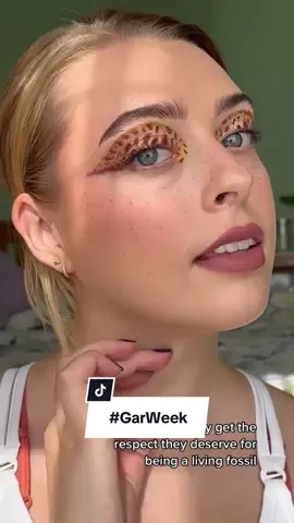 Replying to @Lazer_Bear one more oldie for #GarWeek! This look is based on the spotted gar, a lovely little fish that grows to be 2-3 feet long. They play a vital role in their ecosystem by eating a lot of little critters and growing big, which helps transfer energy and nutrients up the food chain. And they look good doing it 💅 I used @Glisten Cosmetics LTD water activated liners for those iconic spots! #GarWeek #fishface #scicomm #creativemakeup 